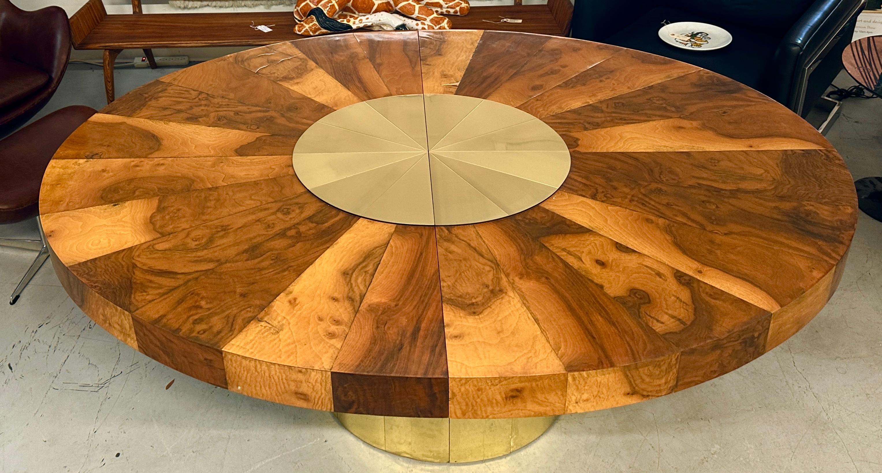 A beautiful 1970’s Paul Evans PE800 for Directional burl walnut and brass dining table. The table is an extension table and has two leaves. It is pictured at first without leaves and measures 73 inches long. We’ve also pictured it with the leaves
