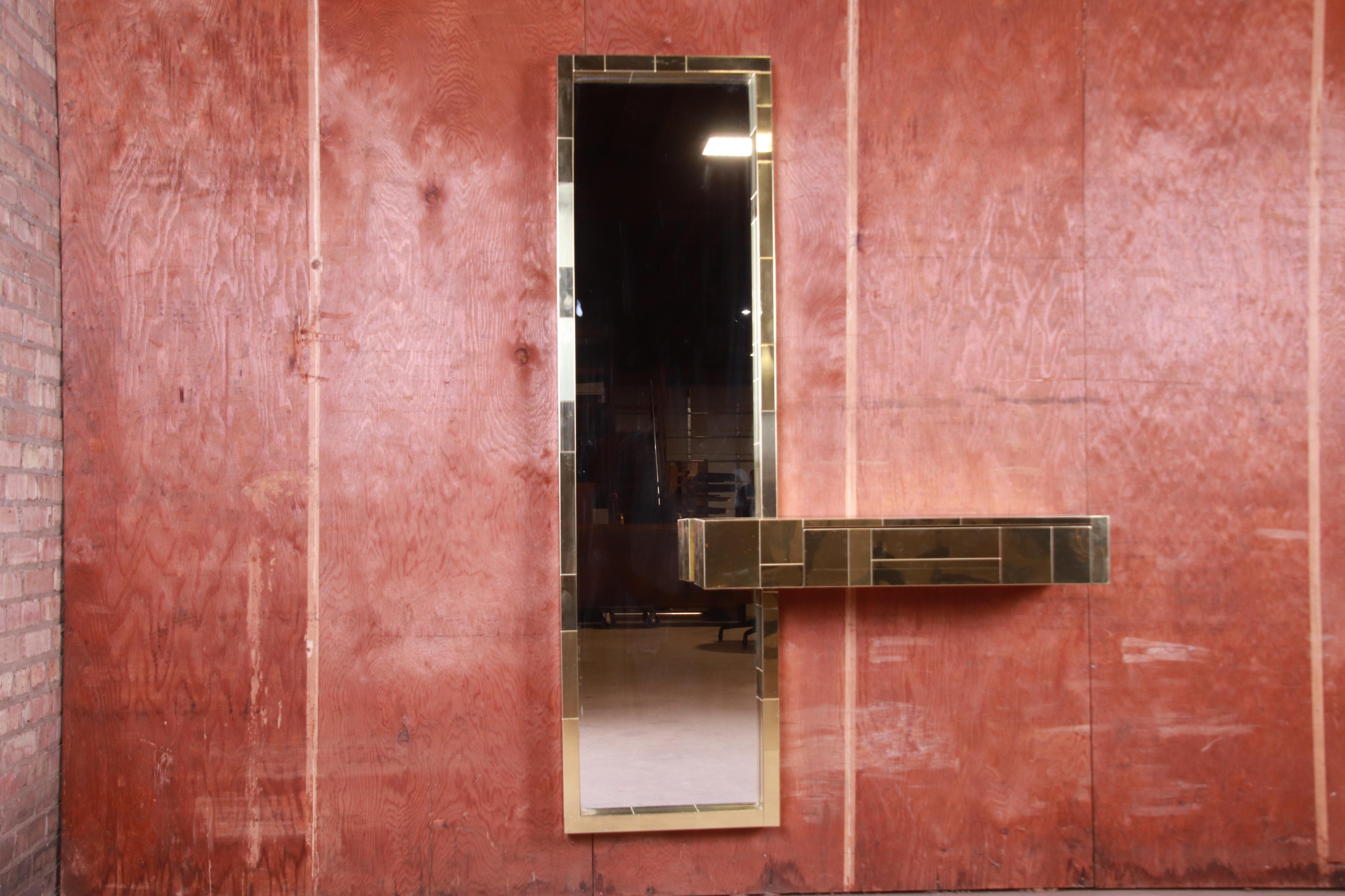 A rare and stunning Mid-Century Modern Hollywood Regency brass-plated mirror and floating console table

By Paul Evans for Directional 