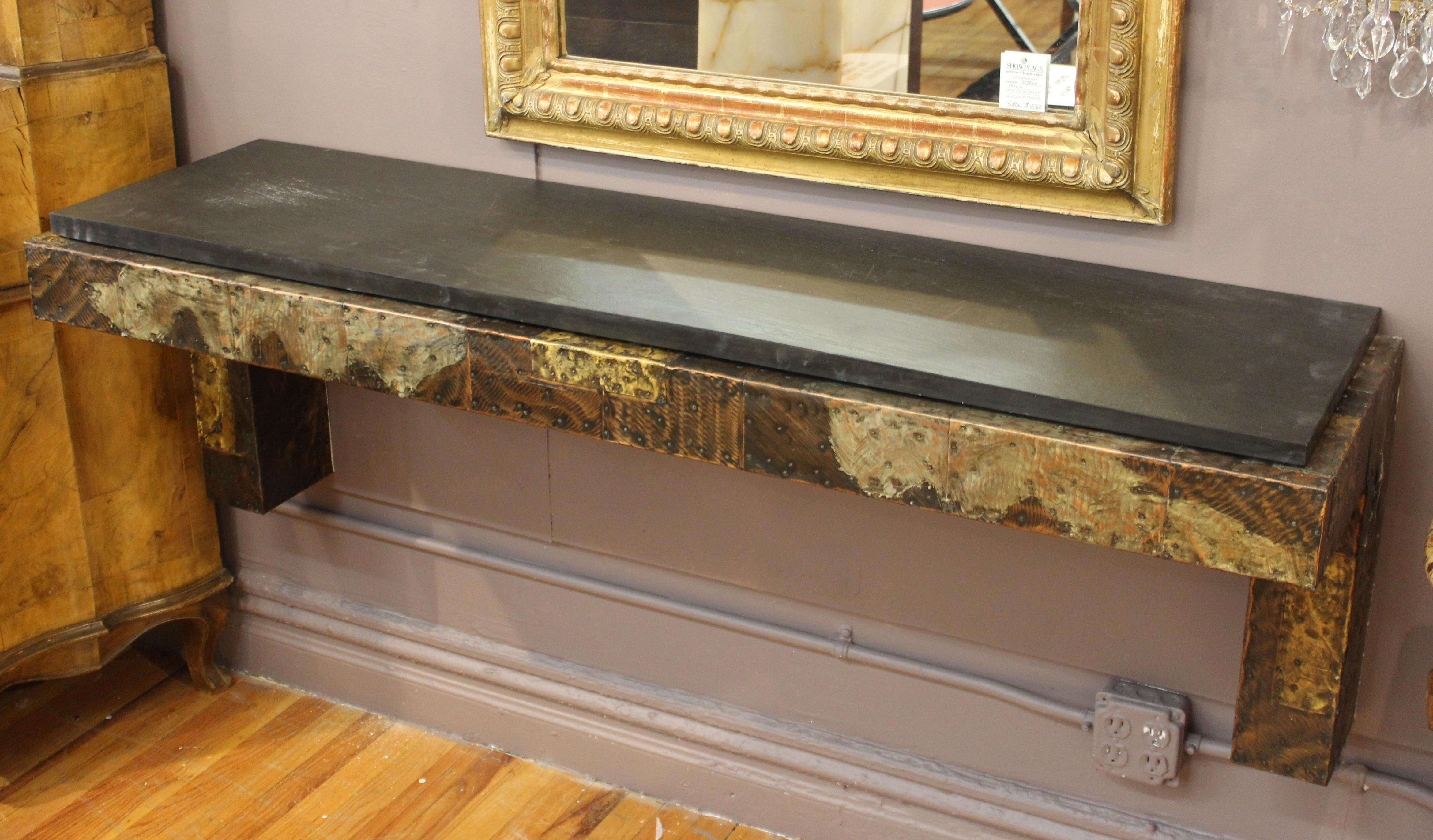 Modern patchwork wall-mounted console designed by Paul Evans for Directional Furniture during the 1970s. The piece is made with a patchwork of copper, brass and pewter and has a slate top. It is in great vintage condition, with some age-appropriate