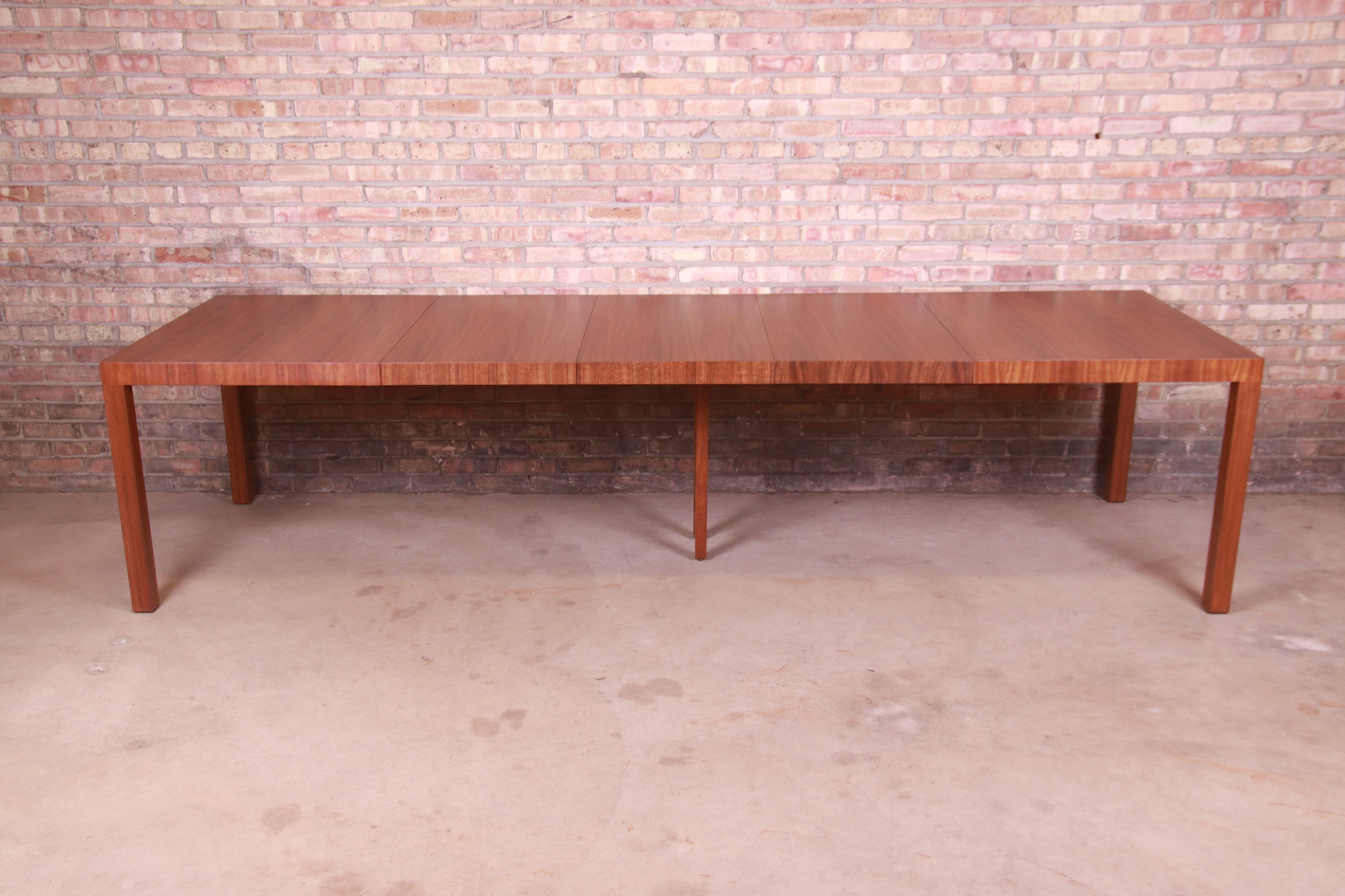 A rare and exceptional Mid-Century Modern Parsons extension dining table in book-matched exotic paldao wood

By Paul Evans for Directional, 