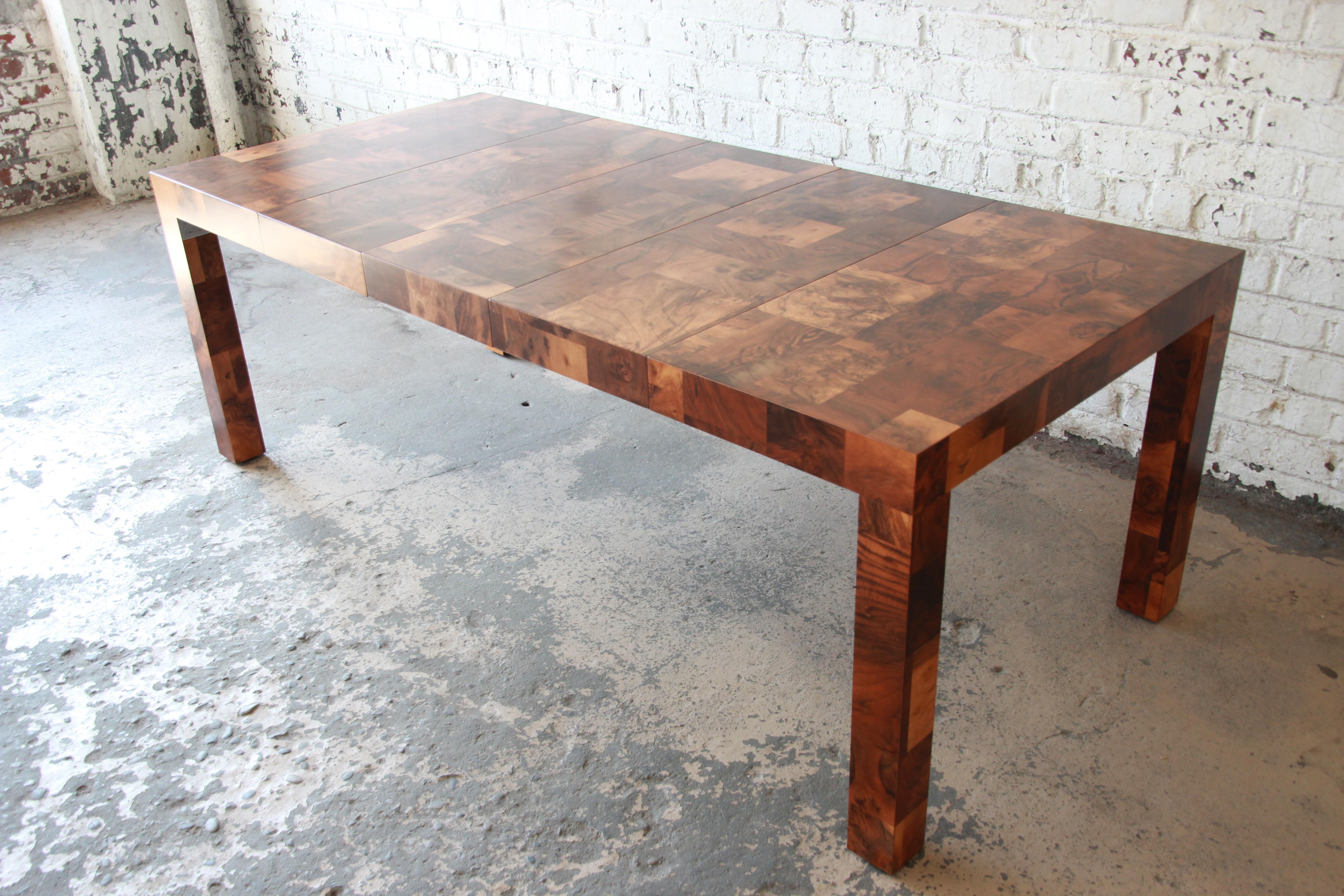 A rare and exceptional Mid-Century Modern Parsons style patchwork burl wood dining table designed by Paul Evans for his 