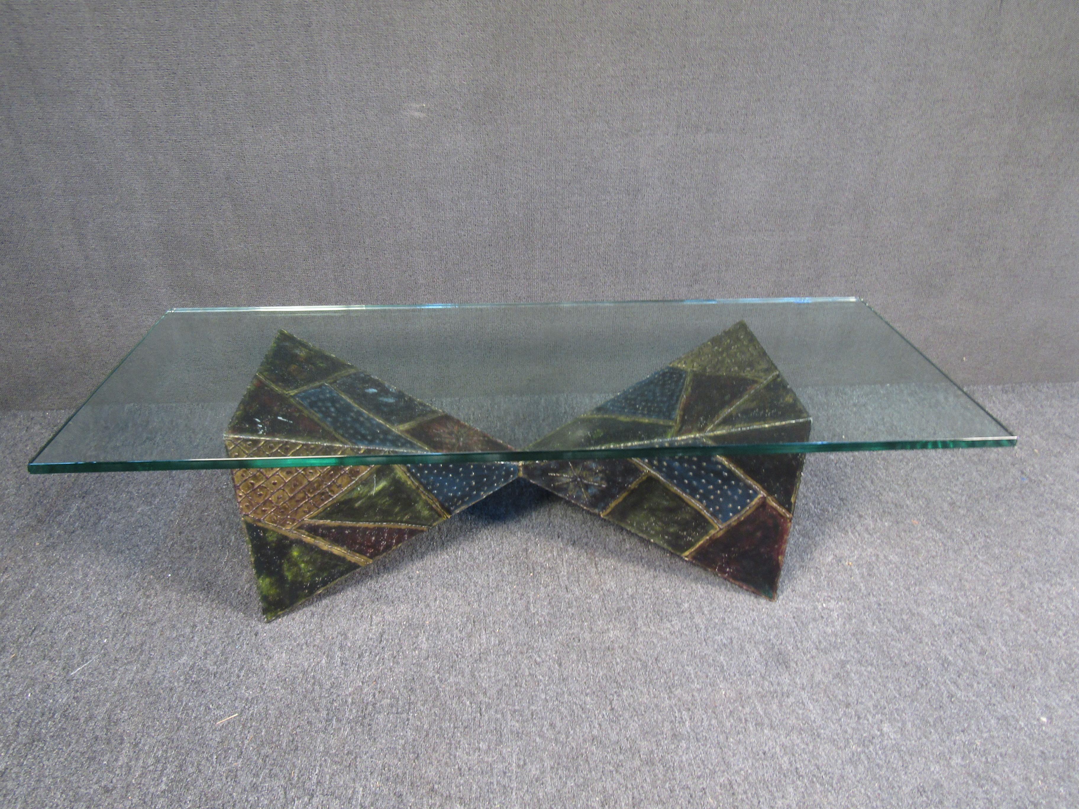 This unique coffee table by Paul Evans features contrasting textures and colors in its geometric base along with a large glass top. Rare and collectible, this vintage table by renowned designer Paul Evans is a bold statement piece anywhere its