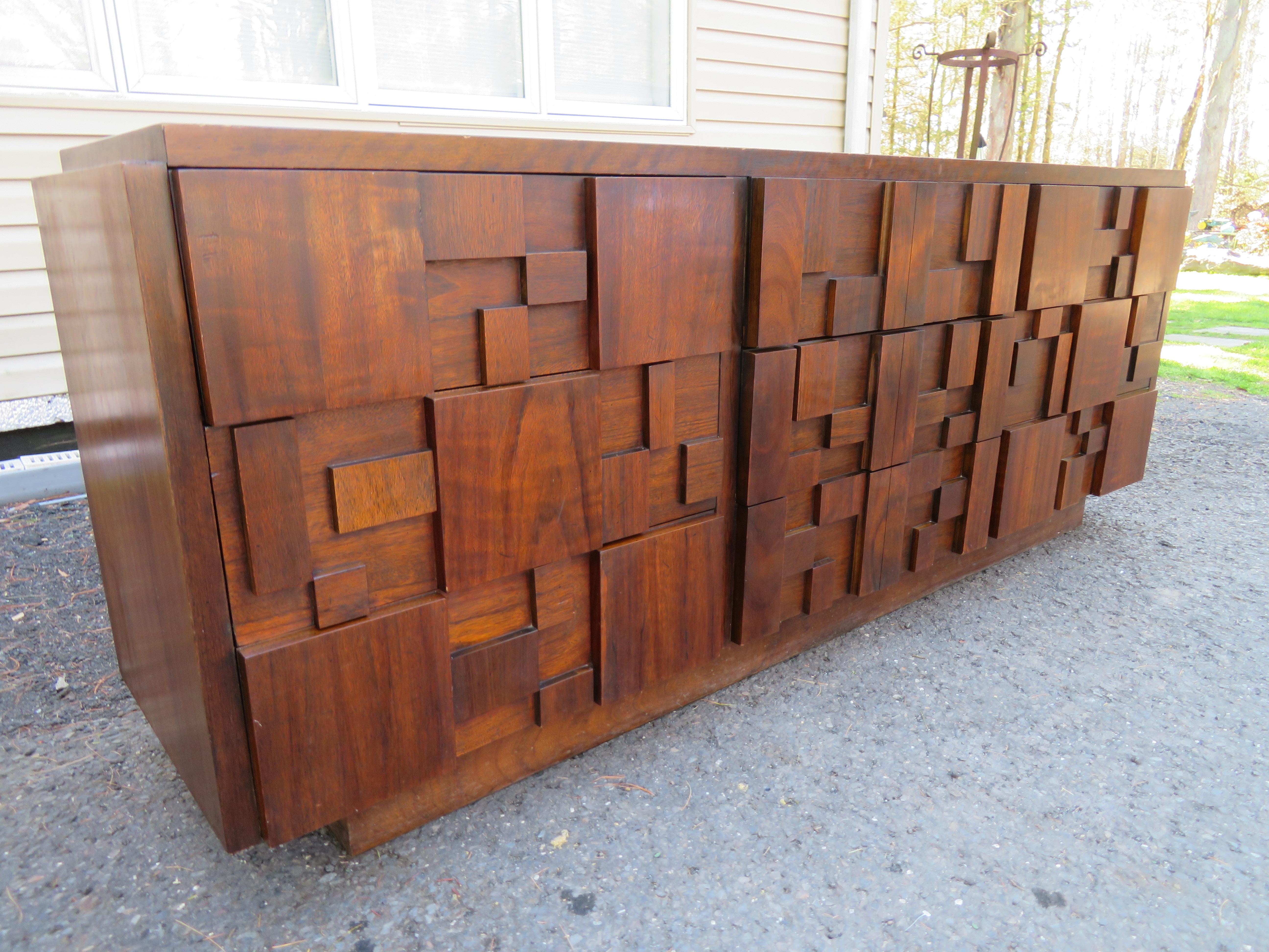 Handsome Paul Evans inspired chunky walnut mosaic credenza made by Lane. This piece is in very nice vintage condition and is very well made. The top has its original finish and looks quite nice. This piece measures 30.5