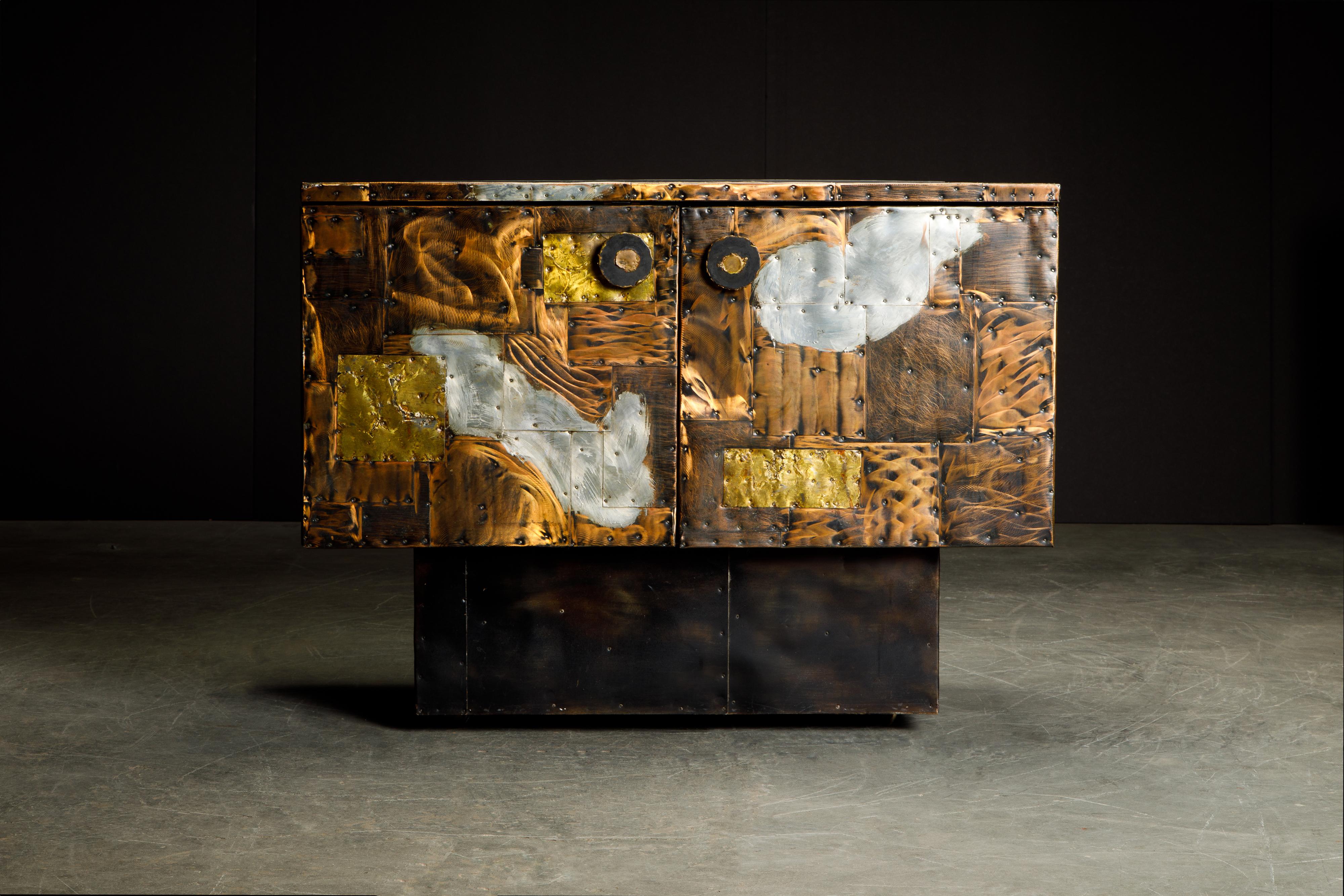 Stunning copper clad cabinet by Paul Evans for Directional, produced in circa 1967. This incredible piece of design history is fabricated from patinated pieces of copper, brass, and pewter which have been welded and nailed in a patchwork style