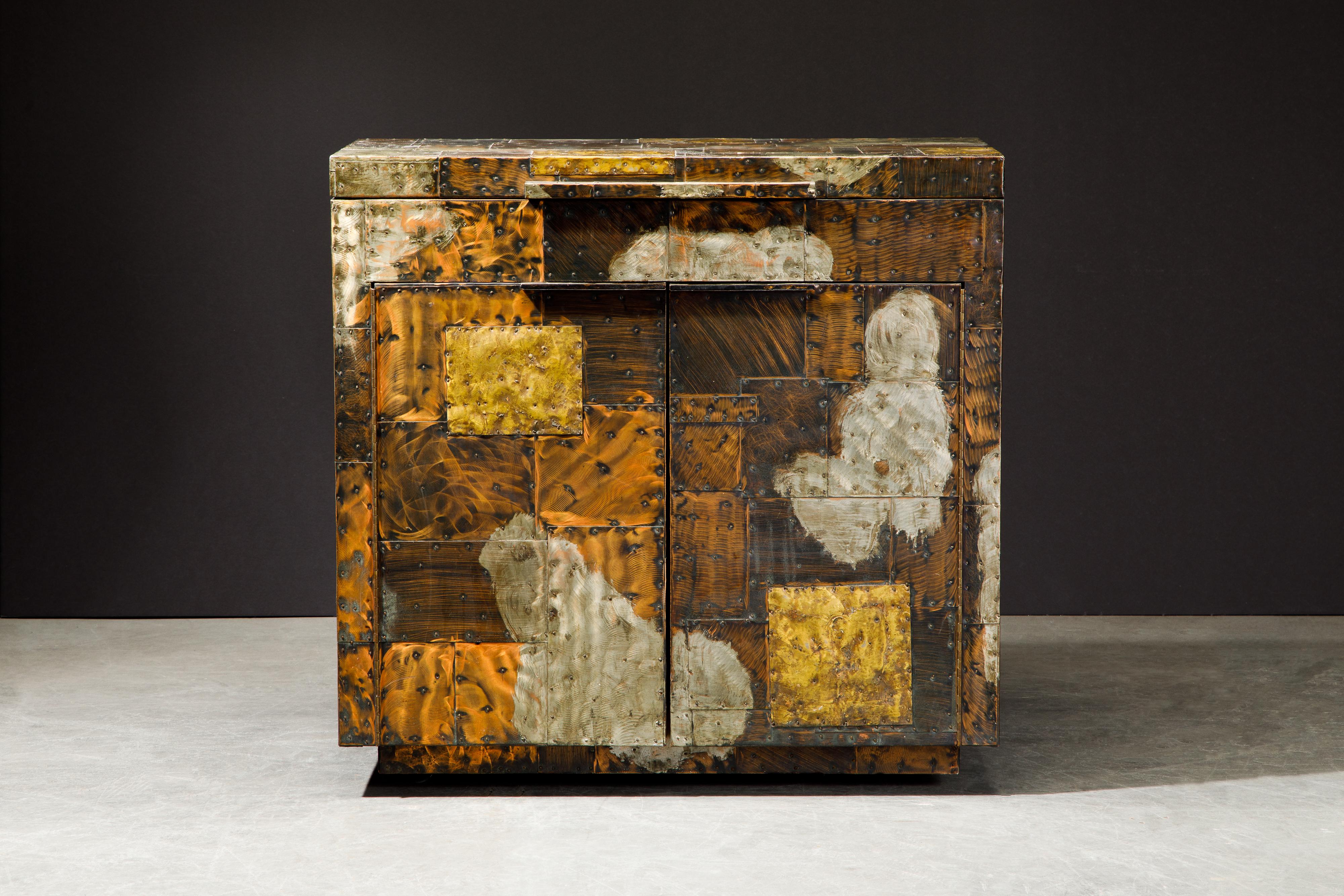 This rare patchwork copper flip topdry bar by Paul Evans was crafted in the mid-1960s by Directional. A collectors item and piece of design history, this stunning liquor cabinet was handcrafted with patinated pieces of copper, brass, and pewter