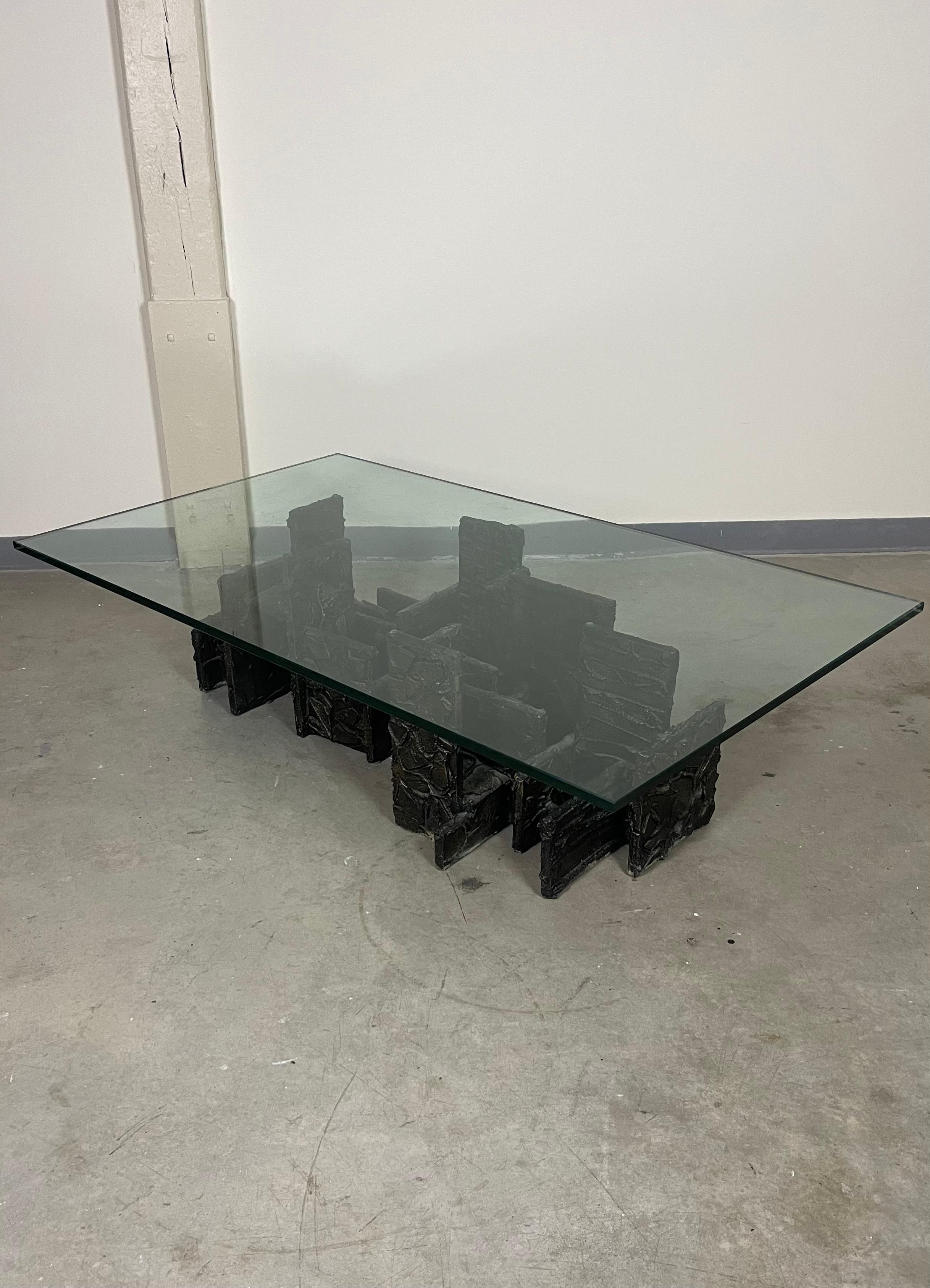 Model PE-131 coffee table in sculpted bronze by esteemed American designer Paul Evans. This piece is inscribed as “PE 71” in the bronze, indicative that the piece was created by Evans in 1971. Current glass contains surface scratches, recommended to
