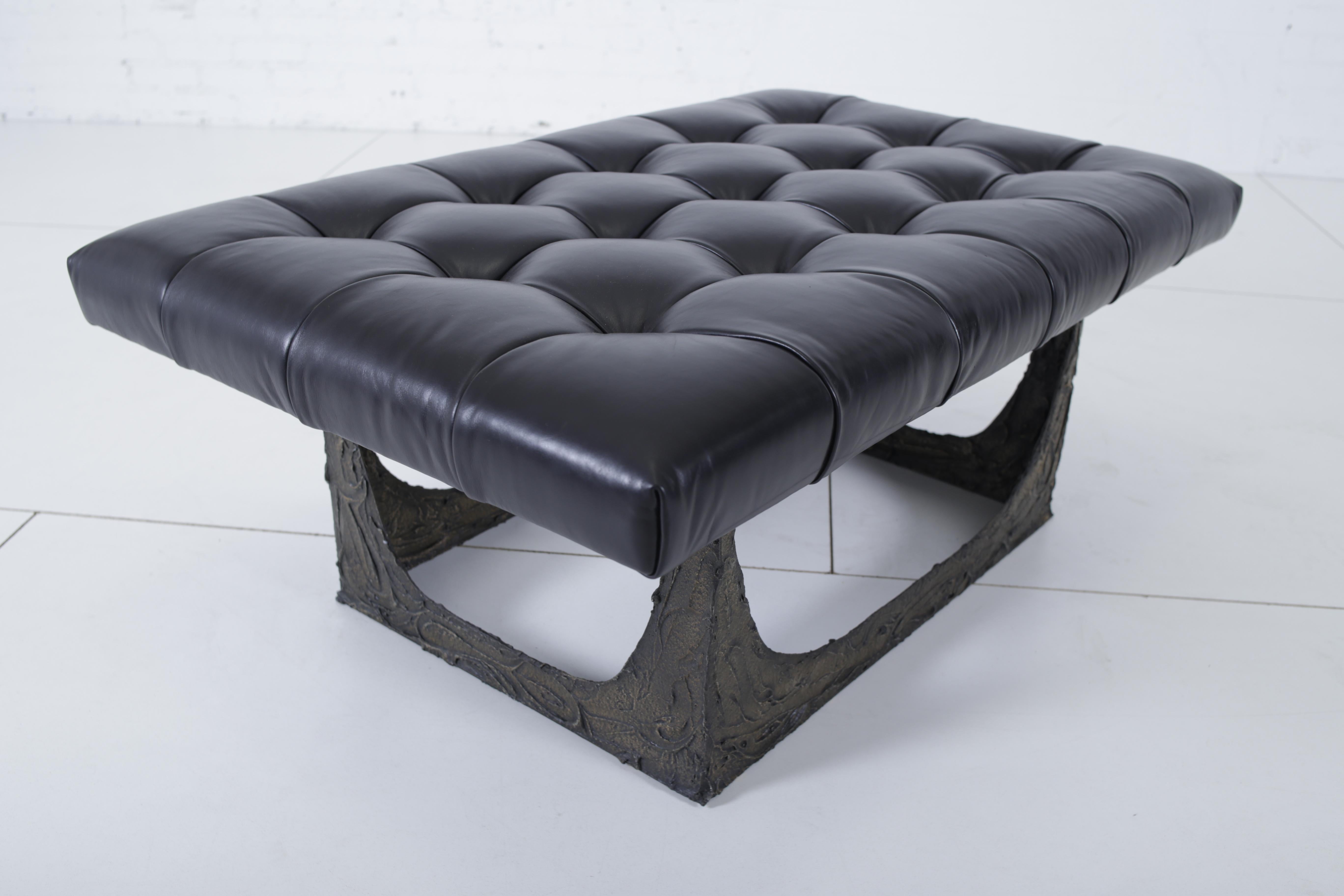 Sculpted bronze bench by Paul Evans. New black leather upholstery. Signed “PE 69”.
  