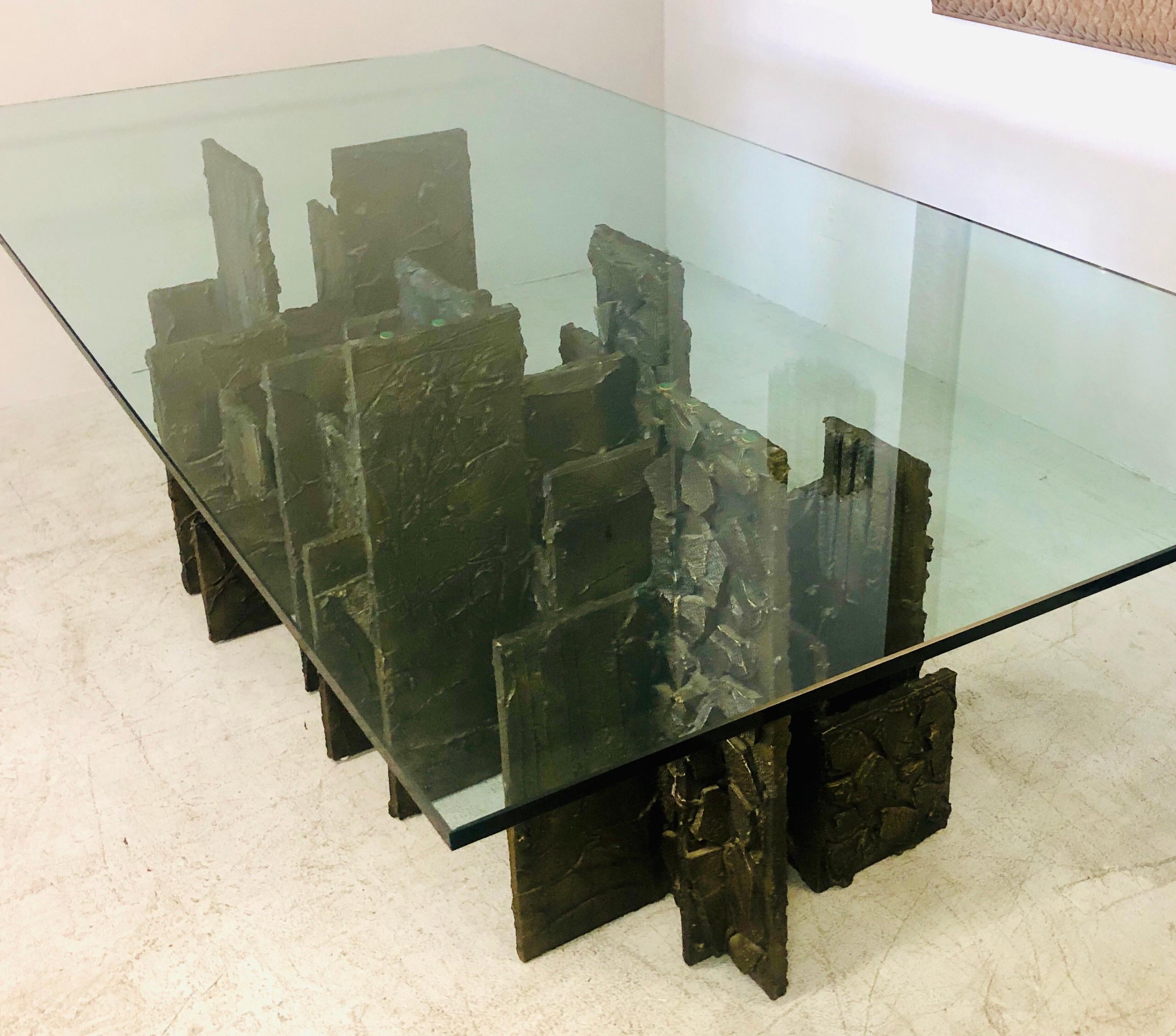 A Paul Evans dining table in the sculpted bronze technic. Multiple rectangular elements are arranged in a skyline manner. The rectilinear angular design is complemented by rich abstract bronze textures. Retains the 96