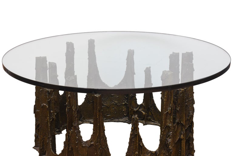 This wonderful signed sculpted Paul Evans cocktail table from 1976 looks like molten castle drippings of bronze of varying heights in brutalist and crown forms. It is called the stalagmite table. Signed PE76. it has a glass top. It needs no other