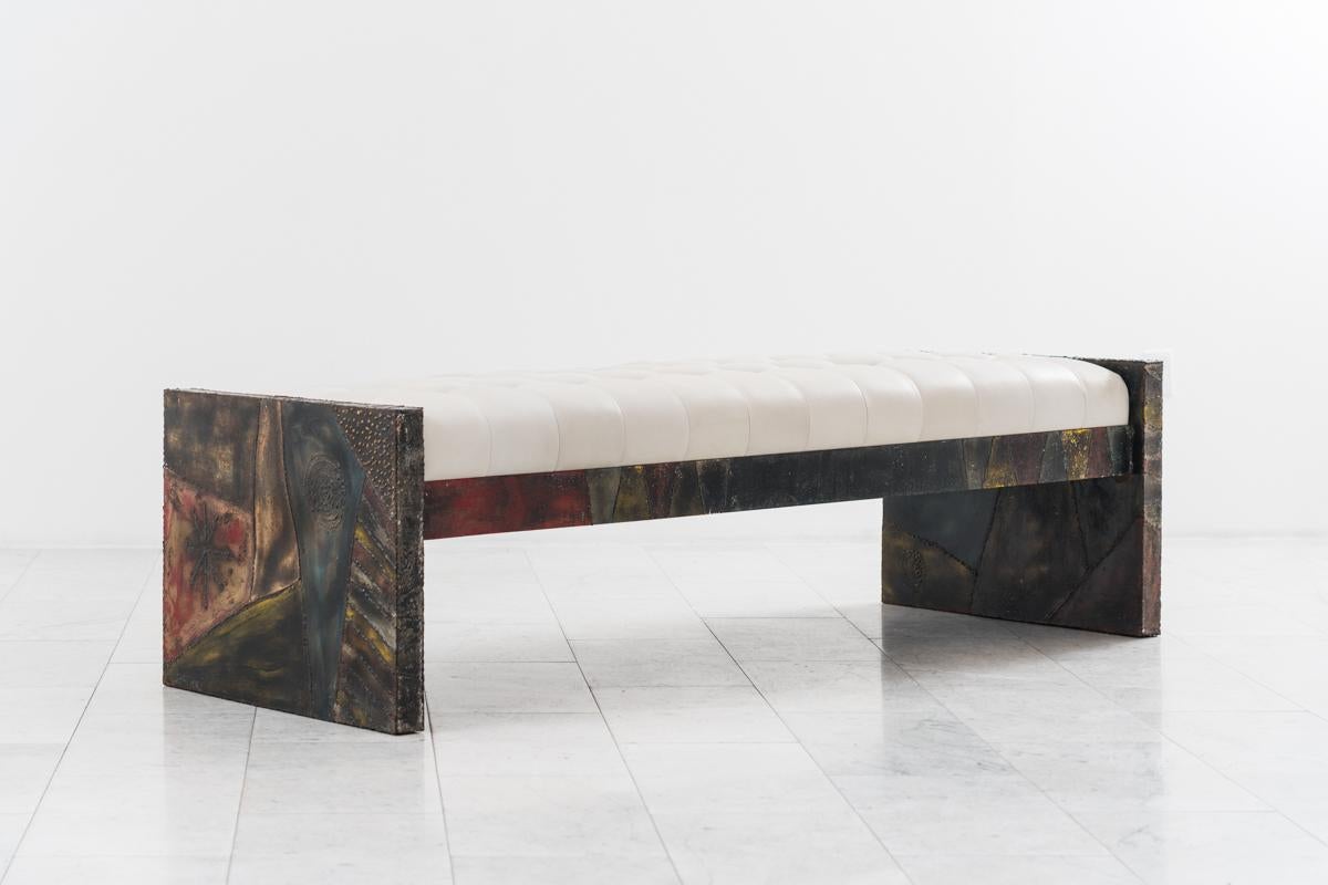 The technique Evan’s used to create this sculpted steel bench combines welded steel, decorative brass braising, and polychromed enamel. This vivid treatment, which resulted in vibrant works with dynamic pictorial surfaces, was very successful for