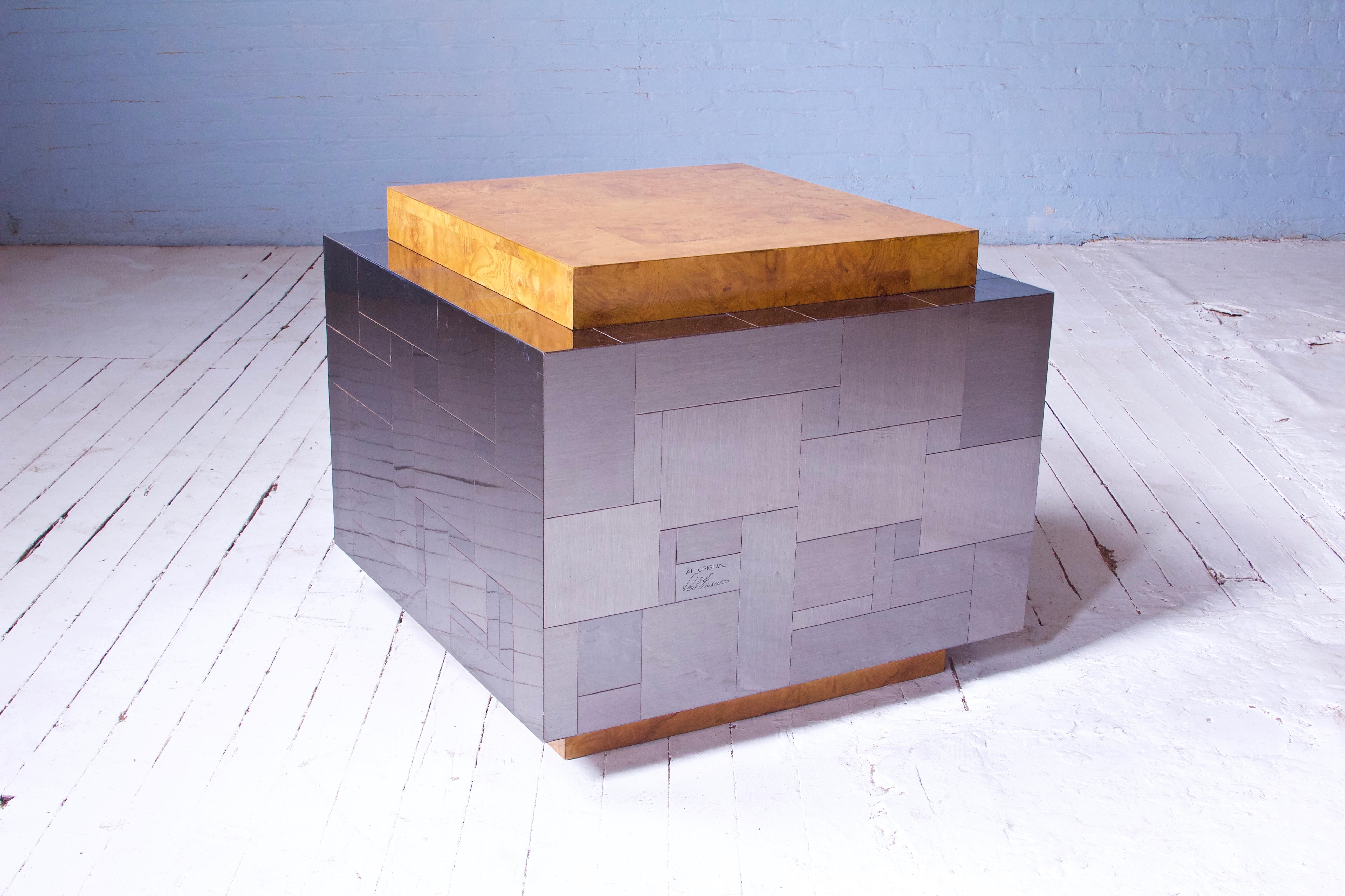 A lovely example of Paul Evans' influential 'cityscape' for directional cube table in olive ash burlwood and mixed metal patchwork panels--signature present. Great patination and warmth to veneer wood patches, and attractive oxidation to gunmetal