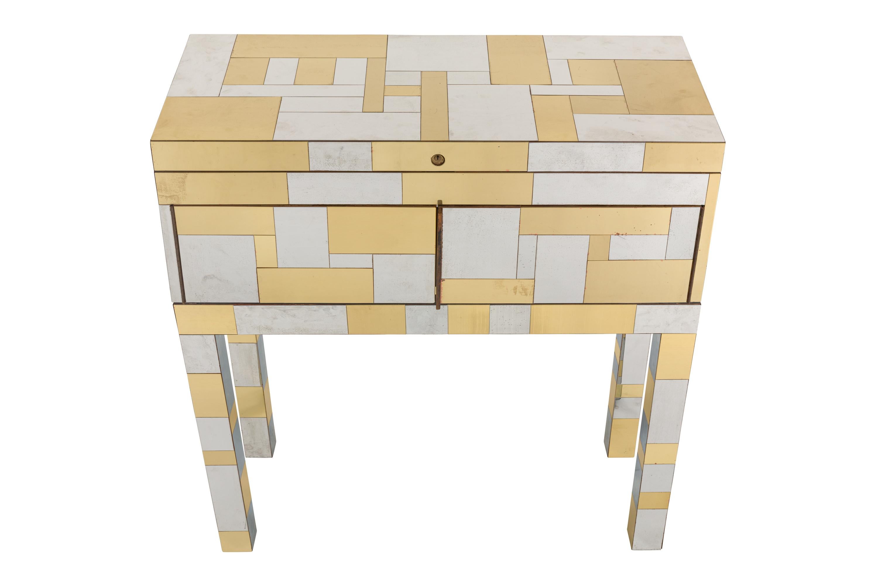 Chest features hinged top concealing twenty one finish sample cubes offered in the Cityscape Collection. and two doors concealing open storage containing a sample hinge and additional samples of veneer. Etched signature to reverse 