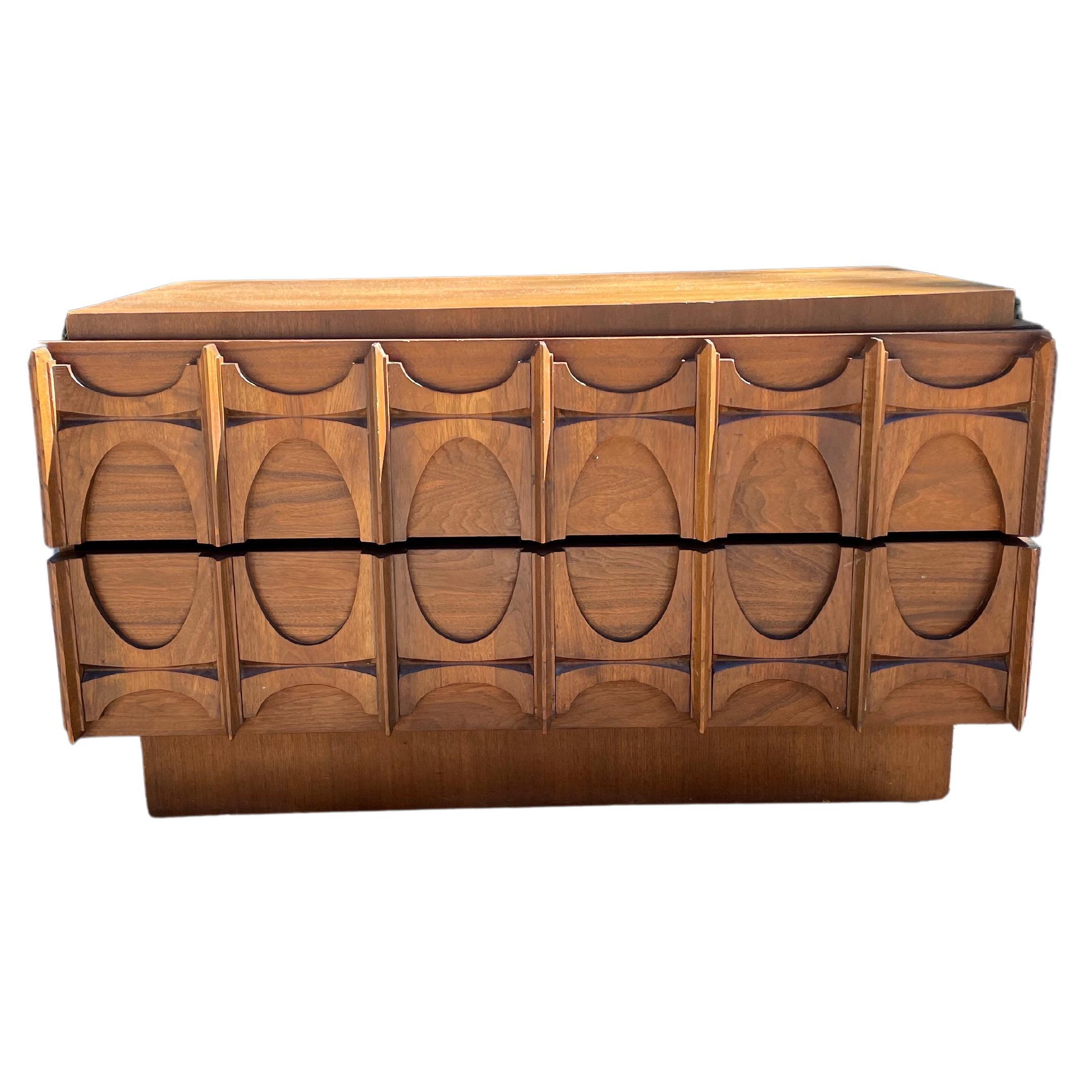 Paul Evans style brutalist credenza chest by Tobago, Circa 1970s. Two carved walnut drawers with gorgeous lines.

Picture this credenza paired with a Lou Hodges Desk and a Michel Ducaroy Marsala leather lounge chair for Ligne Roset.

Dimensions: