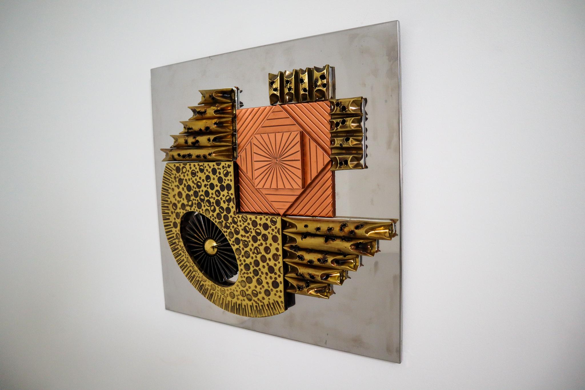 This Brutalist wall sculpture is inspired and in the style of sculptor Paul Avans made circa 1970, Europe. This abstract wall sculpture consist of tortured copper and brass in abstract shapes. The wall sculpture is affixed to a wood board clad made