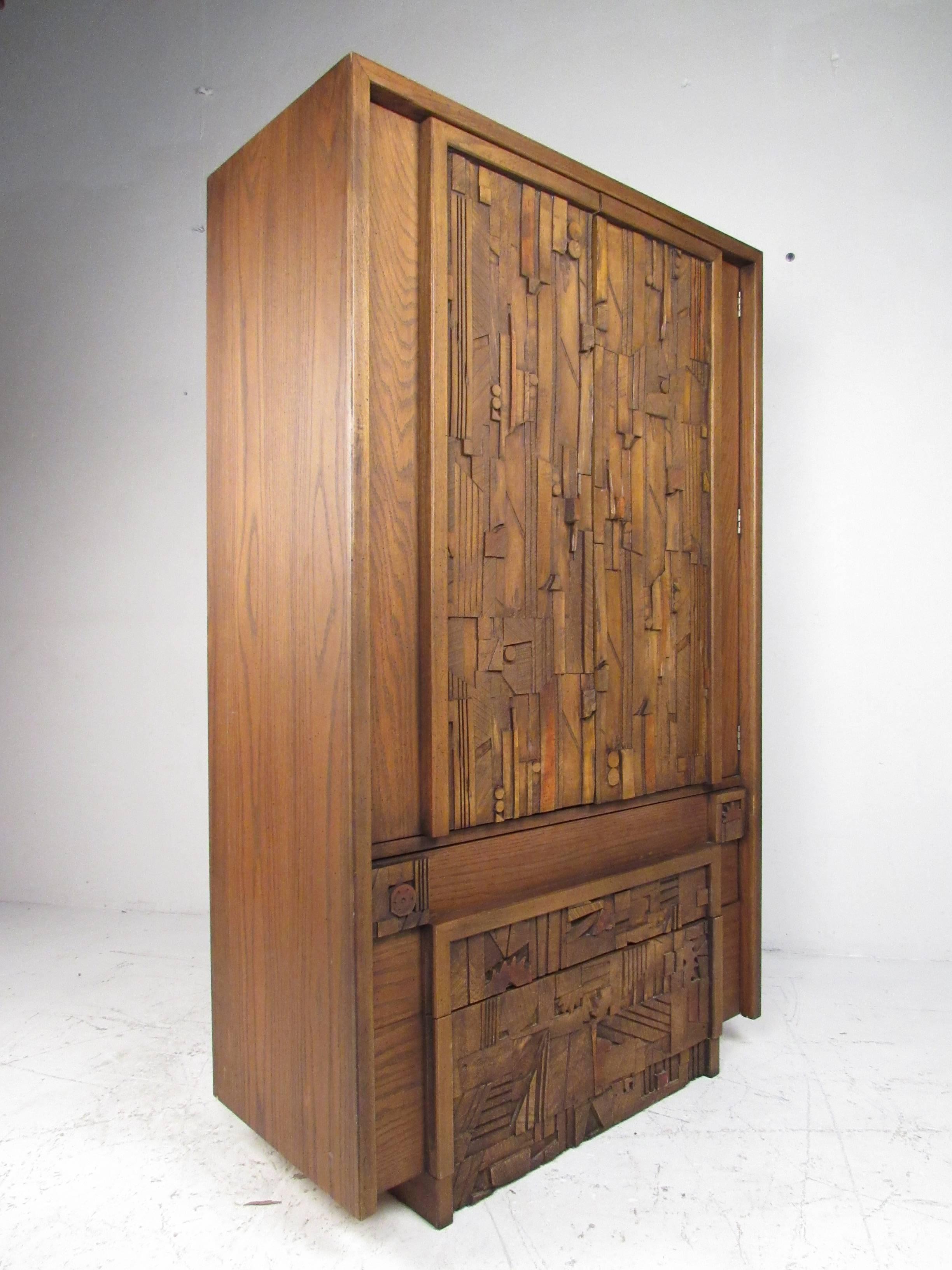 This gorgeous Mid-Century Modern wardrobe features a Brutalist front with exquisite detail. A sleek design with an abundance of storage space hidden behind two cabinet doors. This impressive case piece has four hefty drawers and a large compartment