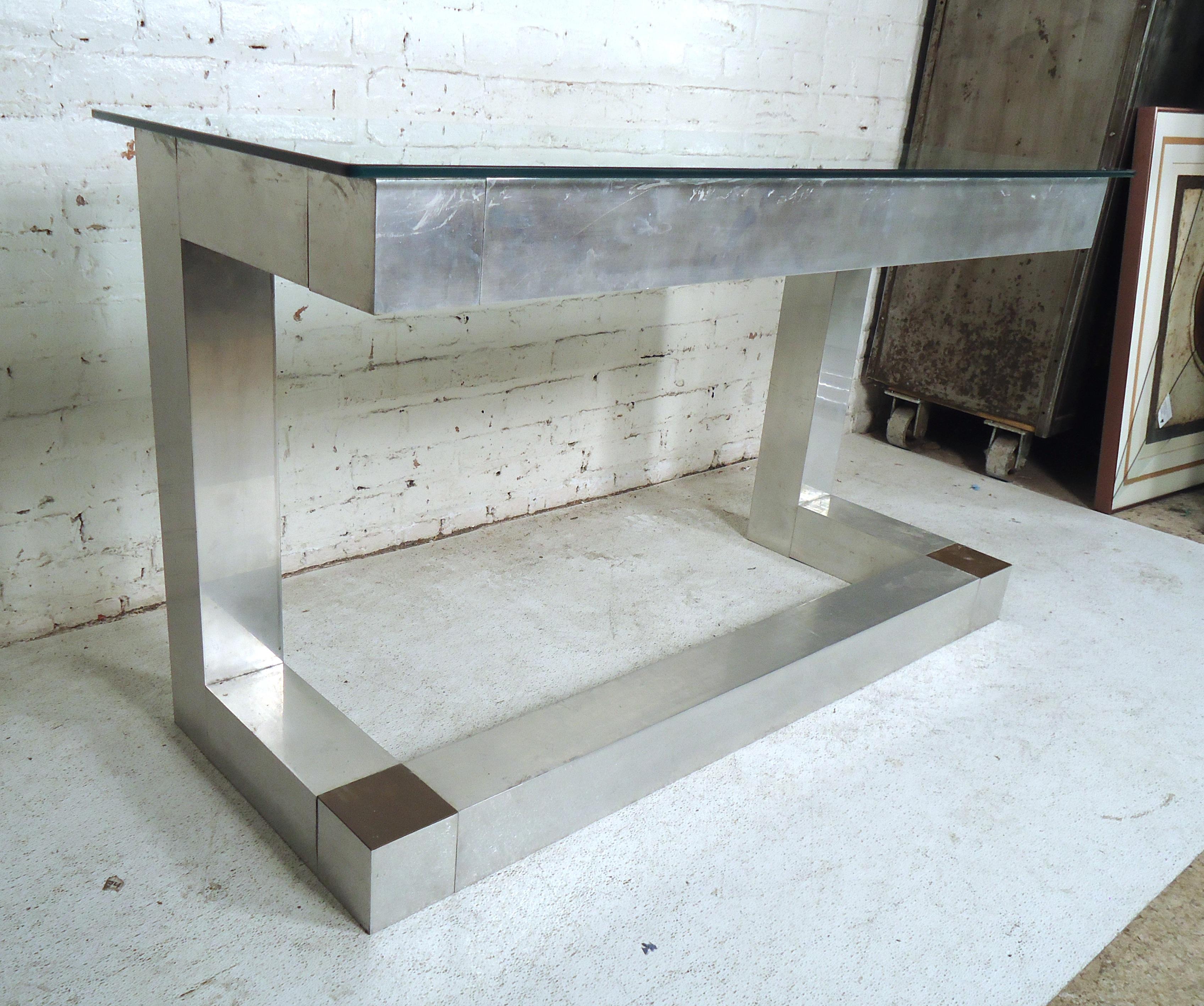 Stylish vintage modern glass top console table in the style of Paul Evans.
(Please confirm item location - NY or NJ - with dealer).