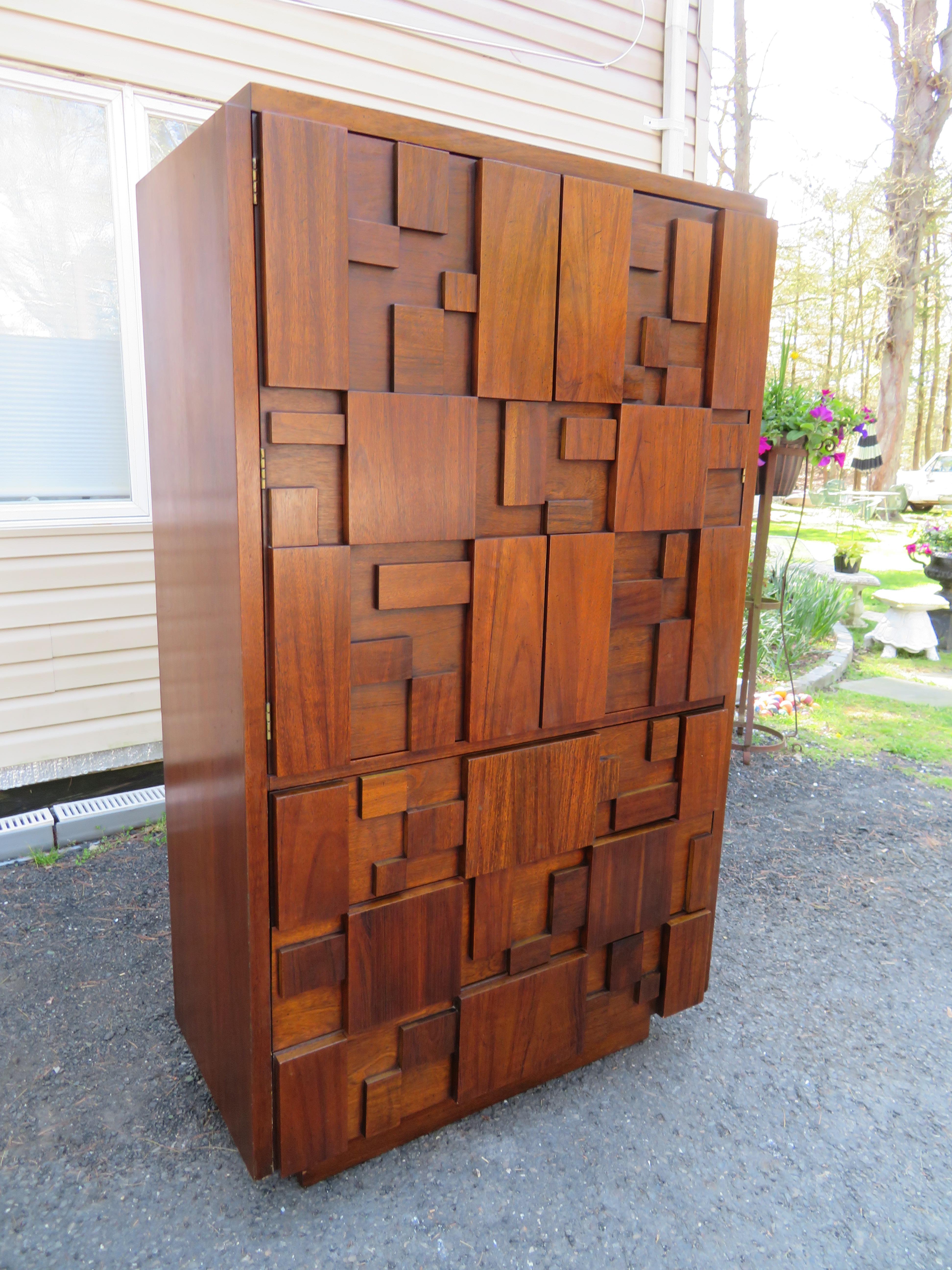 This unique gentleman's chest by Lane furniture features the brutalist mosaic style made popular by Paul Evans. Plenty of storage for any setting, unique cabinet portion features shelf space and an extra drawer. This piece measures 64.25