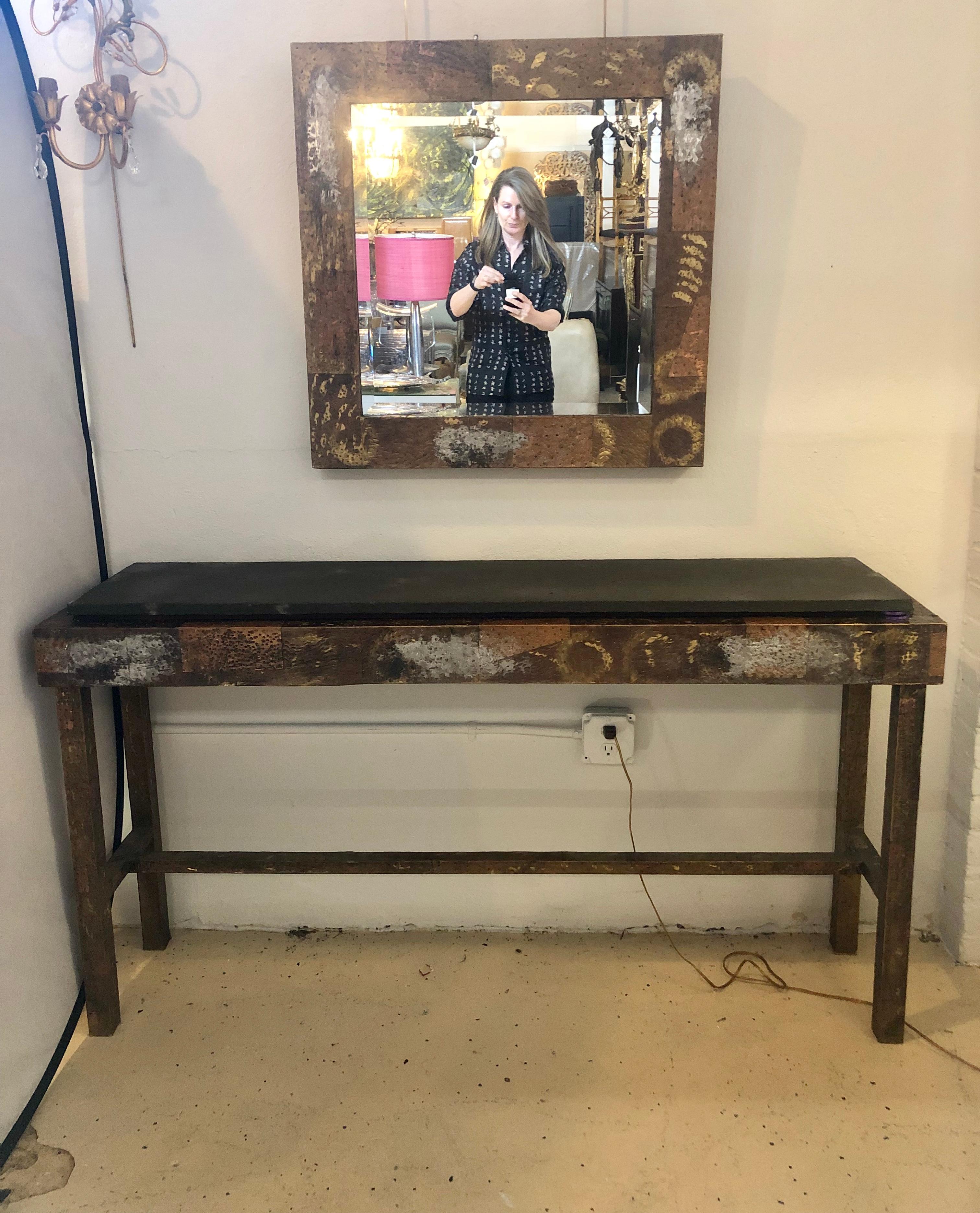 Paul Evans style pair of welded metal slate top consoles with matching beveled mirrors. Can purchase mirrors or consoles separately if necessary.
Paul Evans (1931-1987)
Directional
Custom patchwork console table and mirror, USA, 1970s.
