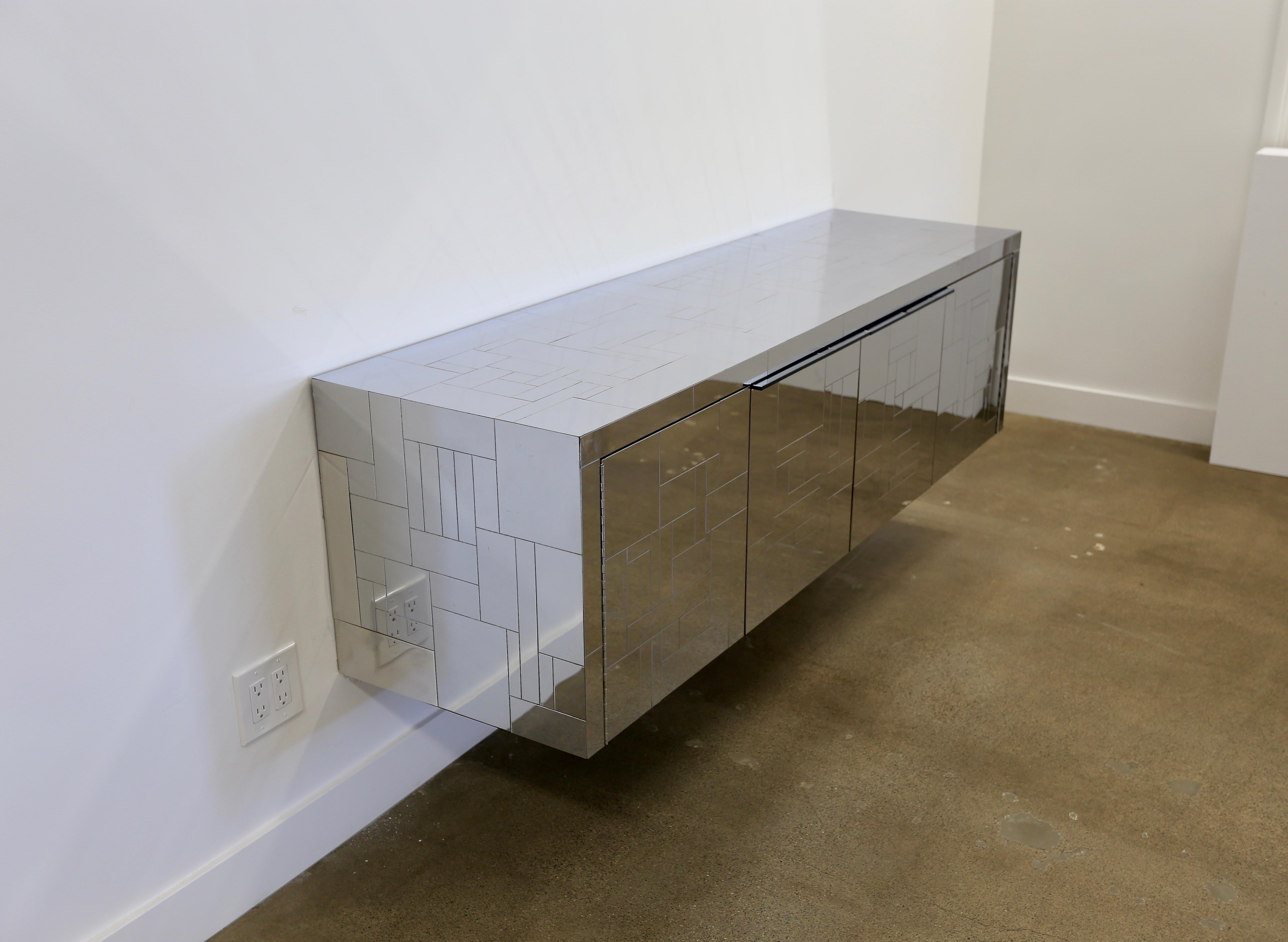 Paul Evans wall-mounted Cityscape cabinet. Manufactured by Paul Evans Studio for Directional, circa 1975. This piece is signed. The chrome-plated steel cityscape detail continues on the bottom of the credenza.