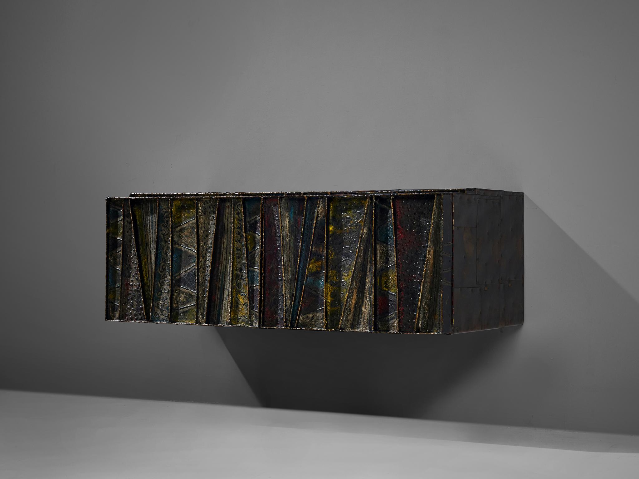 Paul Evans for Paul Evans Studio, deep relief, wall-mounted sideboard model PE-19, welded and patinated steel, slate and darkened wood, United States, circa 1972

Paul Evans 'Deep Relief’ wall-mounted cabinet with welded and patinated steel doors in