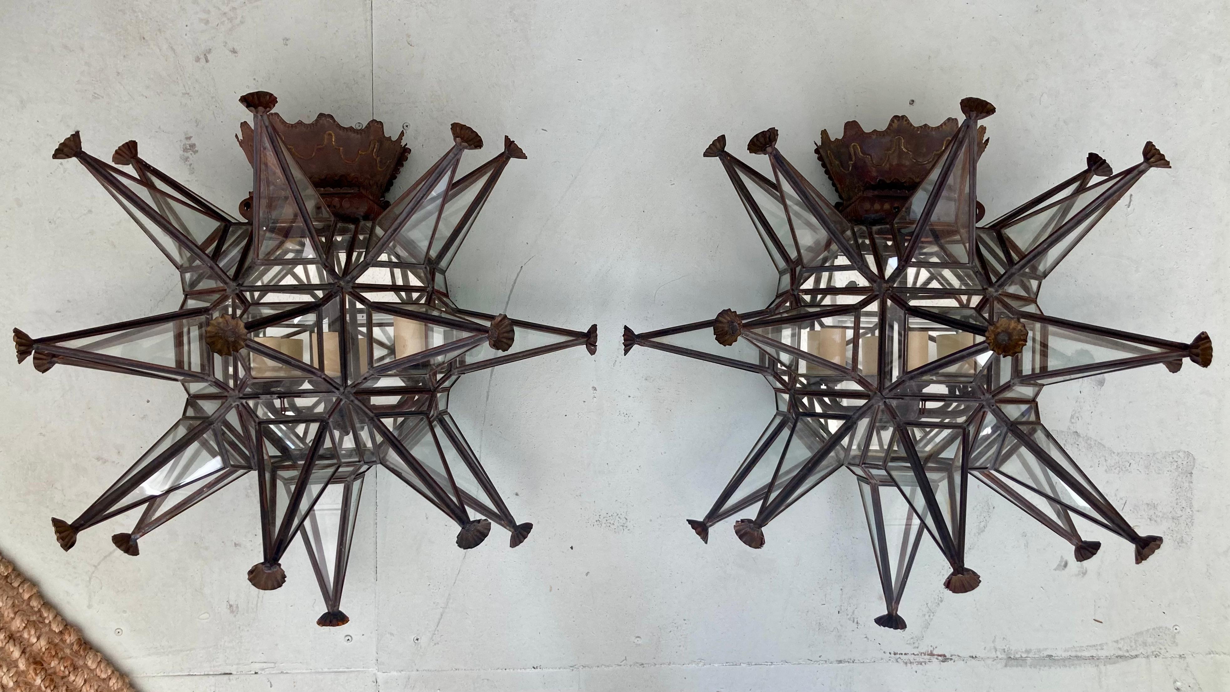 Beautiful pair of Paul Ferrante large scale wall sconces. Very detailed in a star shape. These are very large, dramatic, and also very deep dimensions. They have a 1920s Mizner look to them. Add some architecture to your home.
