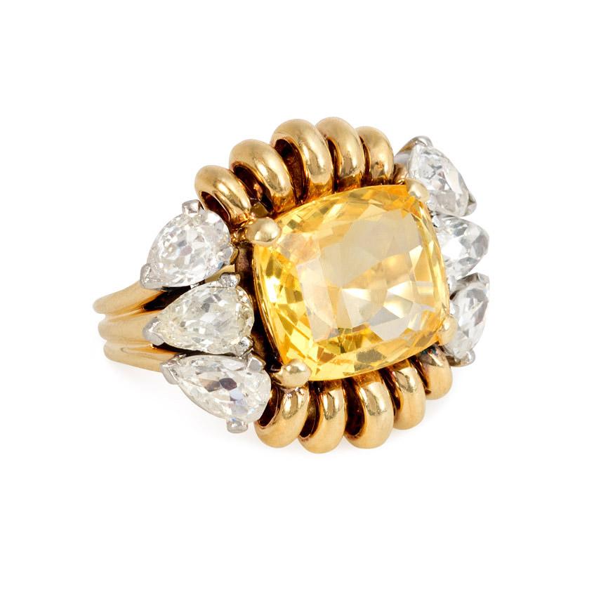 A Retro gold and cushion-cut yellow sapphire ring in a coiled wirework surround and flanked by six pear-shaped diamonds, in 18k.  Paul Flato.  Atw. 2.70 ct. diamonds; approximately 7.00 ct. yellow sapphire.

Top measures approximately 13/16