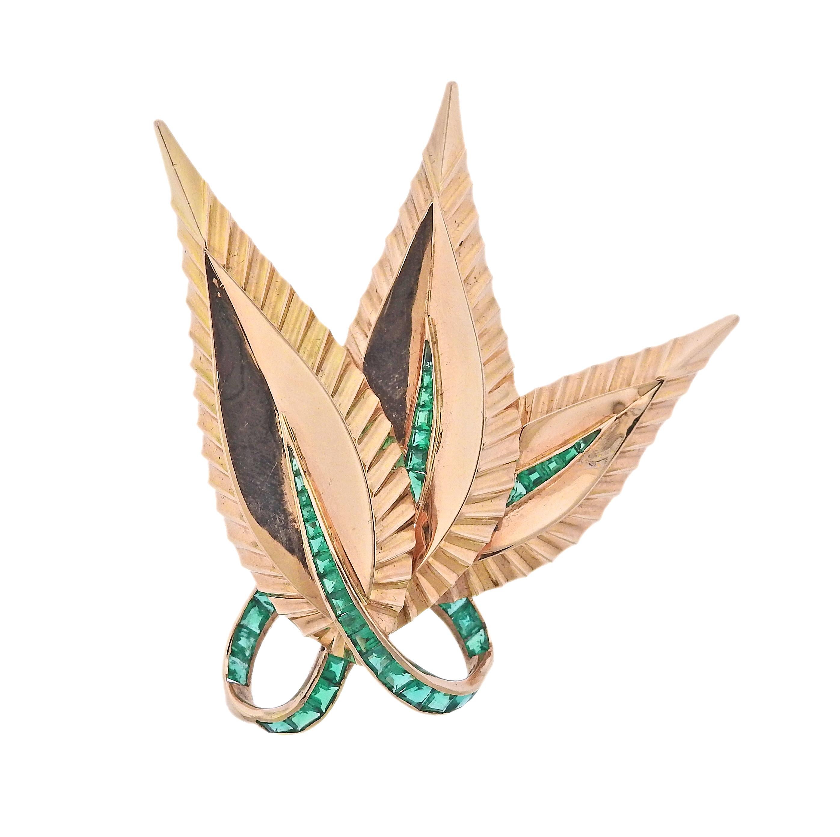 18k yellow gold brooch/pendant by Paul Flato, depicting leaves, decorated with vibrant emeralds. Brooch measures 2.5