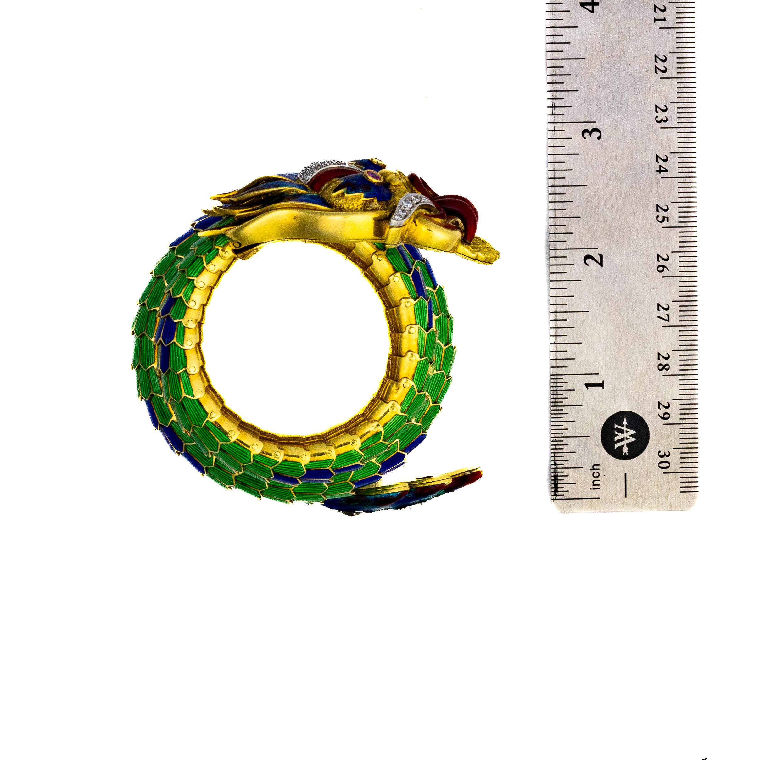 A stunning creation by legendary designer Paul Flato, this Coiled Dragon Bracelet exemplifies the opulence and meticulous craftsmanship that define his work. Crafted in two-tone gold with multicolored enamel, this bracelet features striped green and