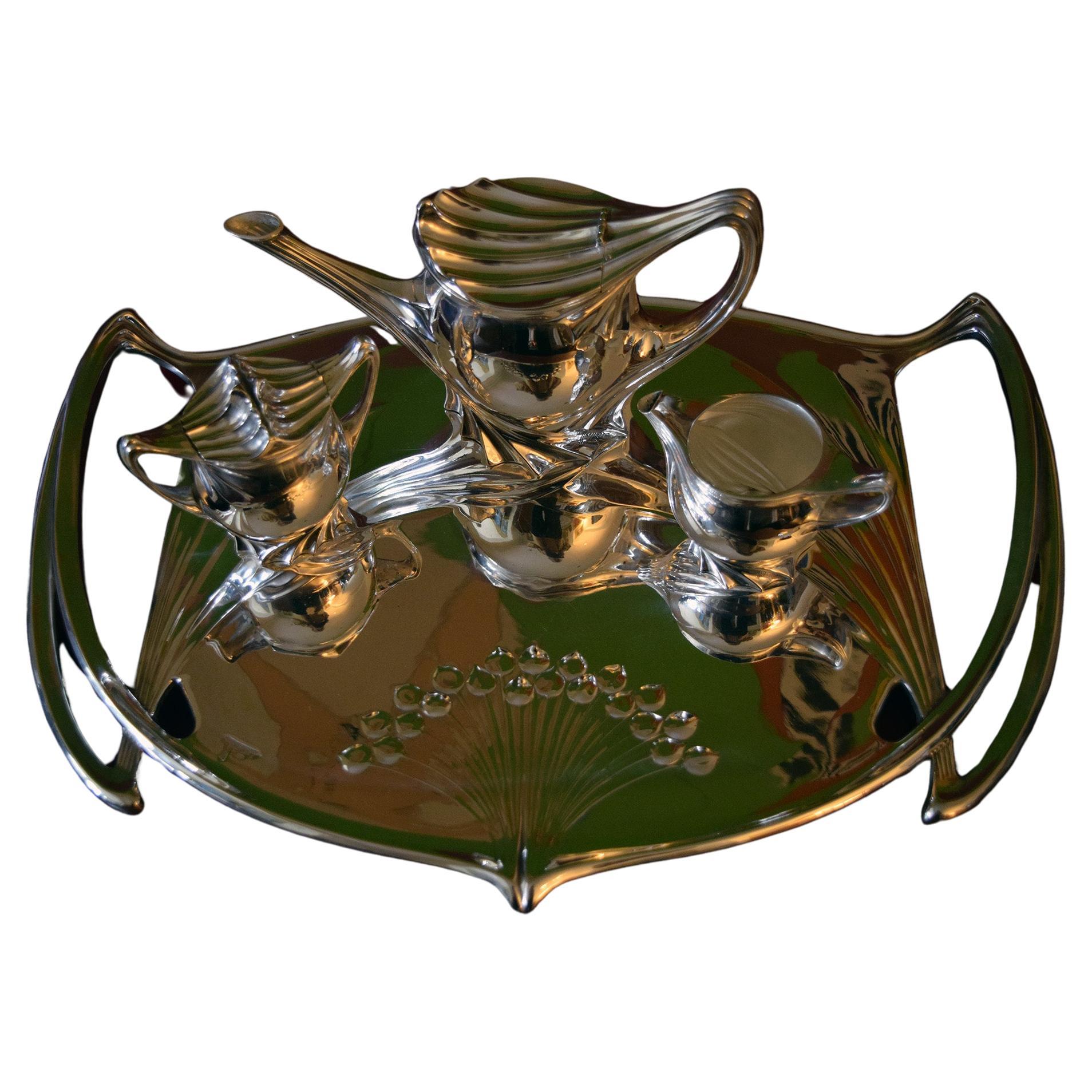 Paul Follot very rare tea set.
This tea set was created in 1904 and is very rare.
It is an extraordinary example of the Art Nouveau period.
It comprises of a tea pot,sugar,milk Jug and tray.
The tray is cast with stylized bouquets and pierced