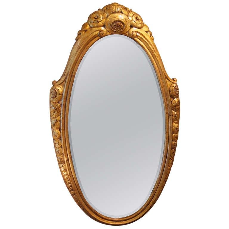 Classic French Art Deco oval wall mirror by Paul Follot in gilt, metal-clad, molded plaster. Circa 1925. 17