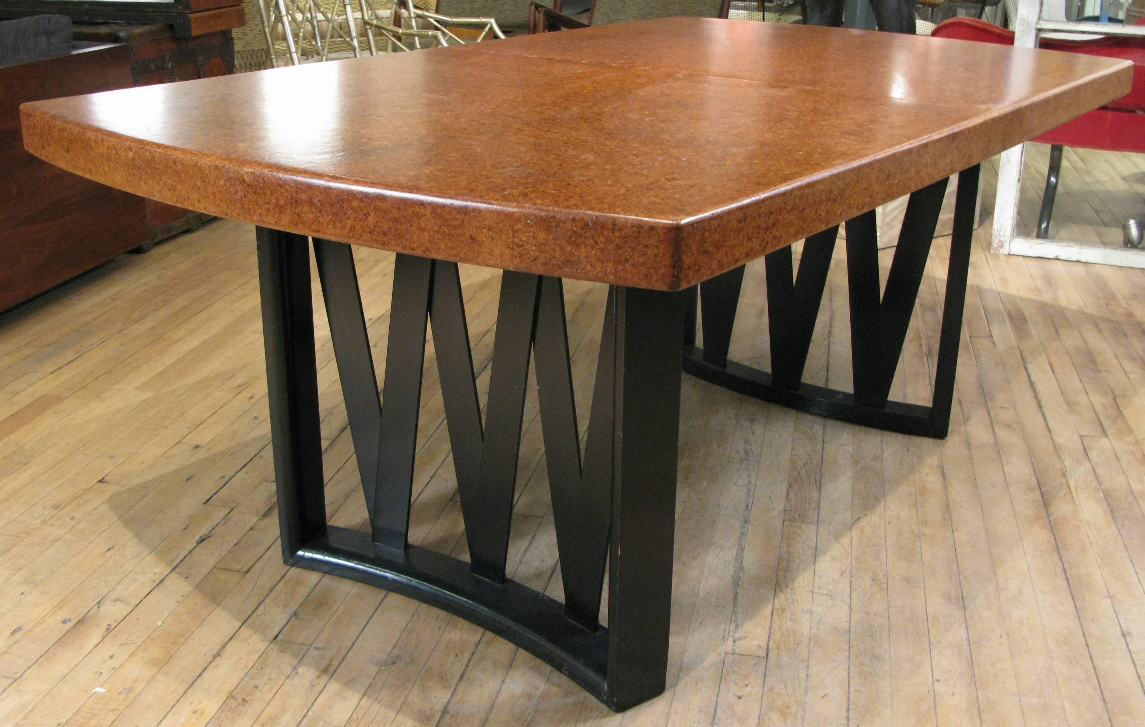 A Classic 1940s extension dining table by Paul Frankl with criss-cross curved ebonized mahogany bases and lacquered cork top. Beautiful warm color on the cork top, with two extension 12