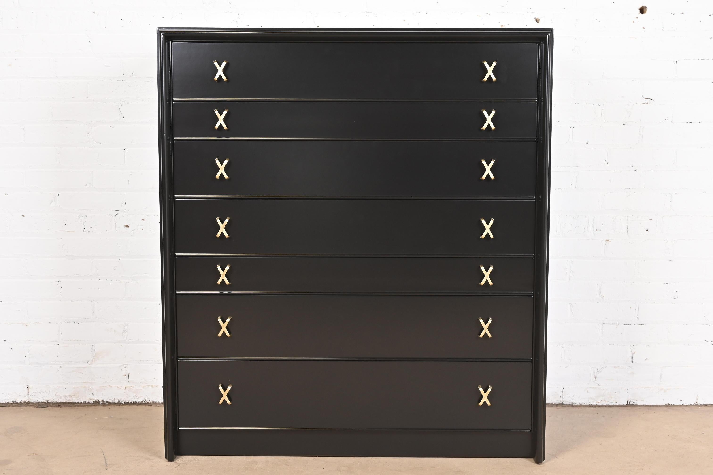 An exceptional Mid-Century Modern black lacquered highboy dresser or chest of drawers with unique drop front secretary desk

By Paul Frankl for Johnson Furniture and retailed by John Stuart

USA, 1950s

Black lacquered walnut, with iconic brass 