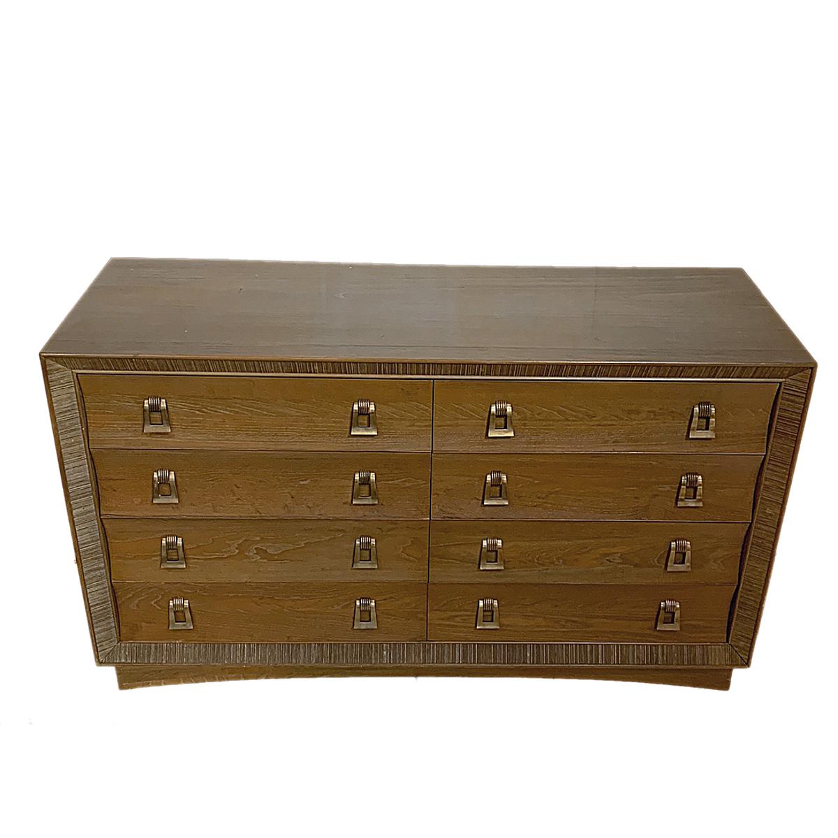Lovely Brown Saltman of California 8-drawer dresser designed by Paul Frankl. Lovely marriage of Art Deco and Mid-Century Modern aesthetic. Gorgeous coursed oak with combed oak detailing. Decorative brass pulls.