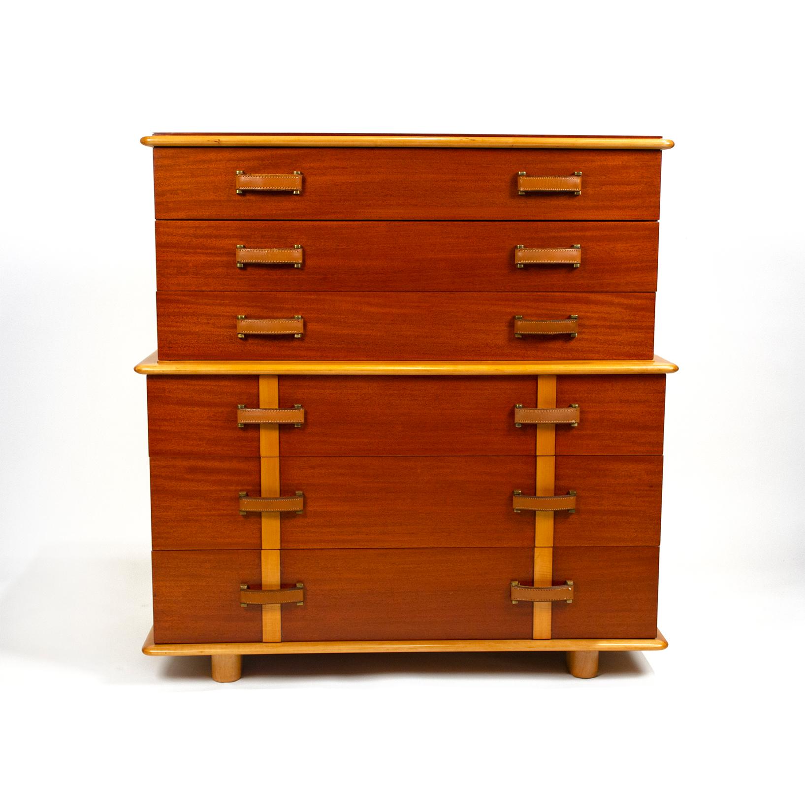 Cabinet constructed of Philippine mahogany and rock maple featuring 6 drawers with original hand-stitched leather handles attached with solid brass hardware. The interiors of the drawers are oak. Manufactured by the Johnson Furniture company in
