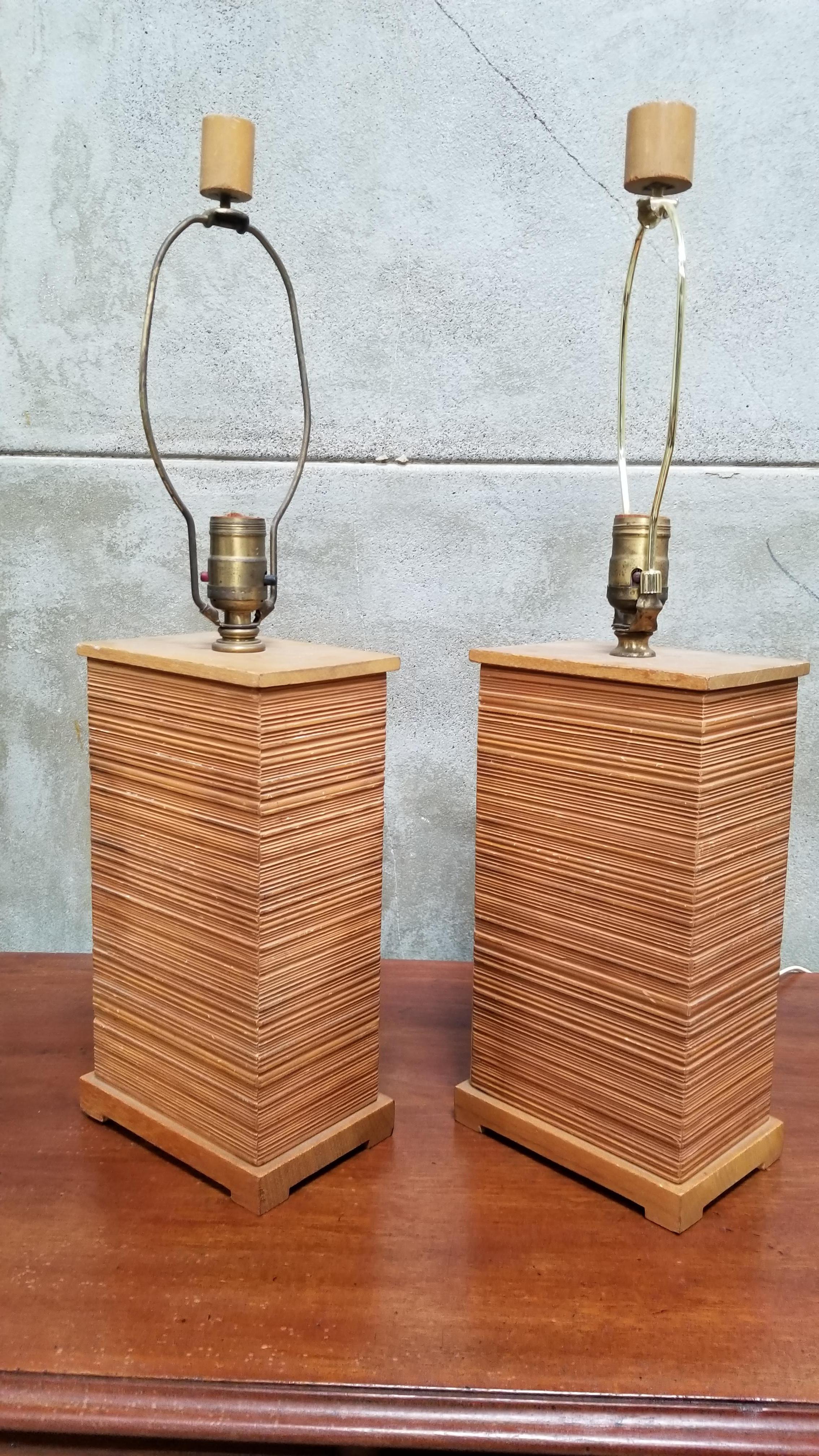 A scarce pair of Mid-Century Modern combed fir table lamps designed by Paul Frankl for Brown-Saltman. Very good, vintage condition with original finish. Original turned wood finials. Original working wiring. Bases only, without sockets measure 6.5