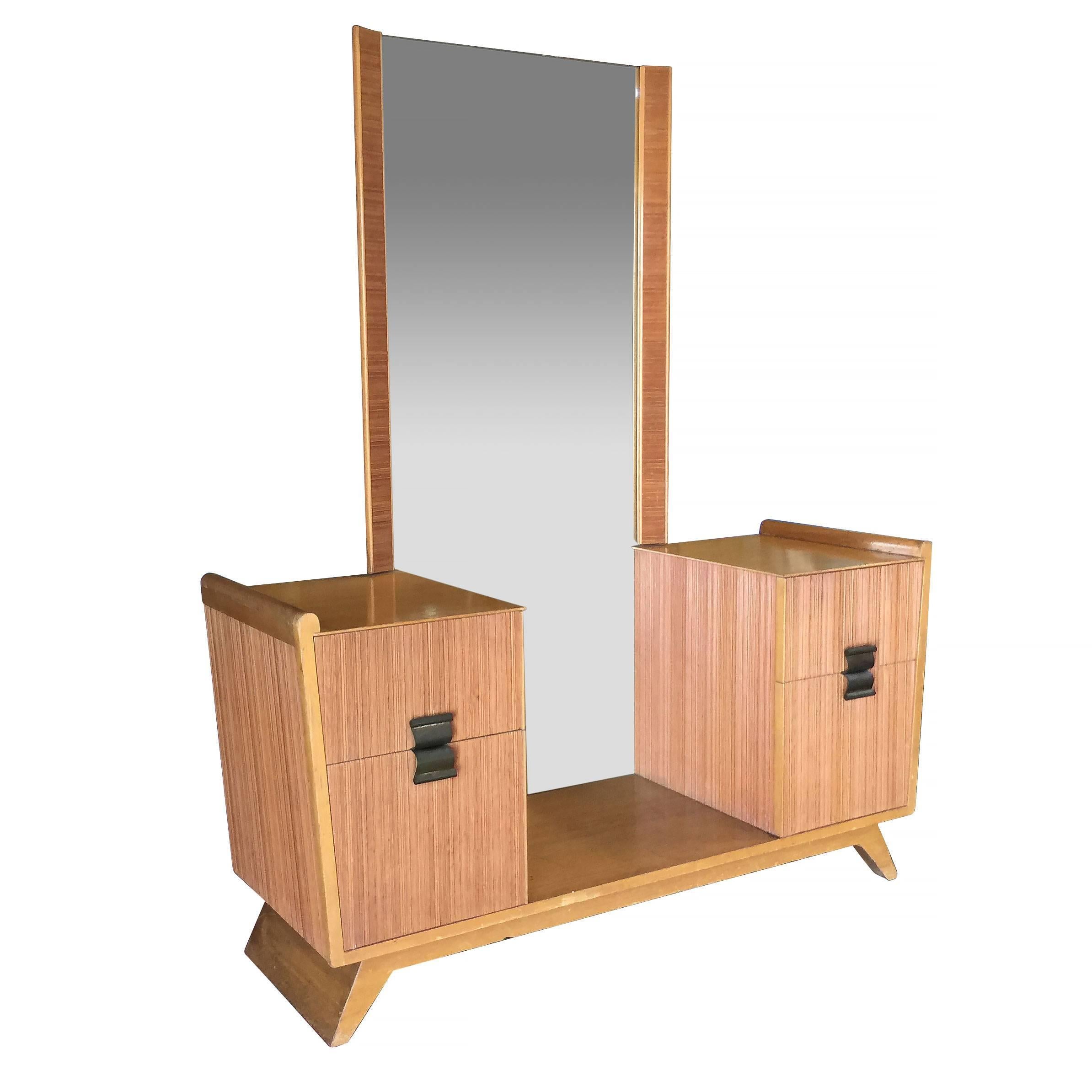 Midcentury vanity with matching stool by Paul Frankl for Brown Saltman company features his trademark combed wood sides with curled brass pulls. Professionally restored. 

Measures: Stool: 18 in. H x 22 in. W x 18 in. D
Vanity: 64.5 in. H x 54
