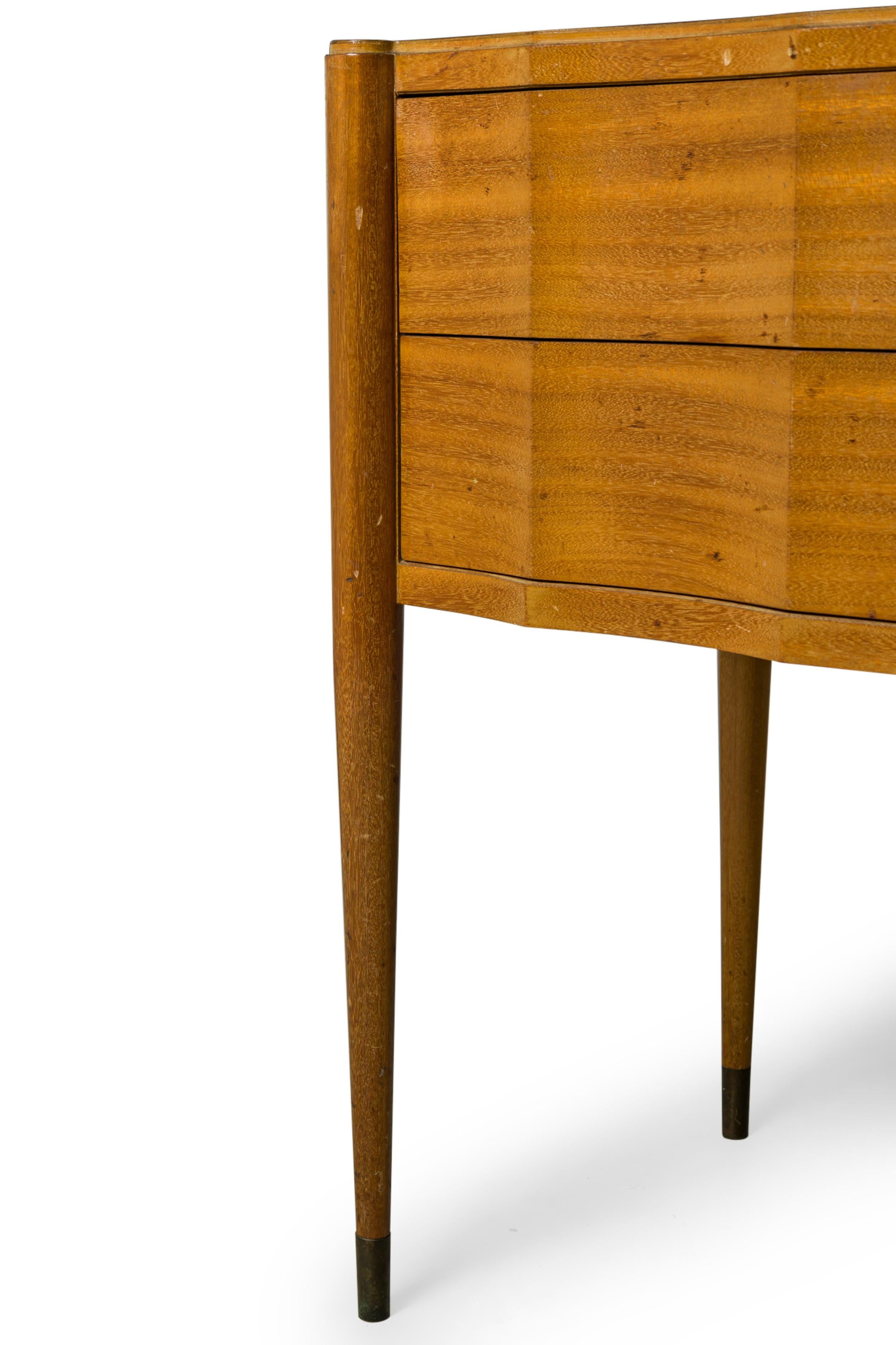 Continental Mid-Century walnut contole table having two drawers with X-shaped brass drawer pulls, resting on four tapered round legs ending in brass sabots. (PAUL FRANKL)

Wear to finish from age & use, discoloration to table top finish.