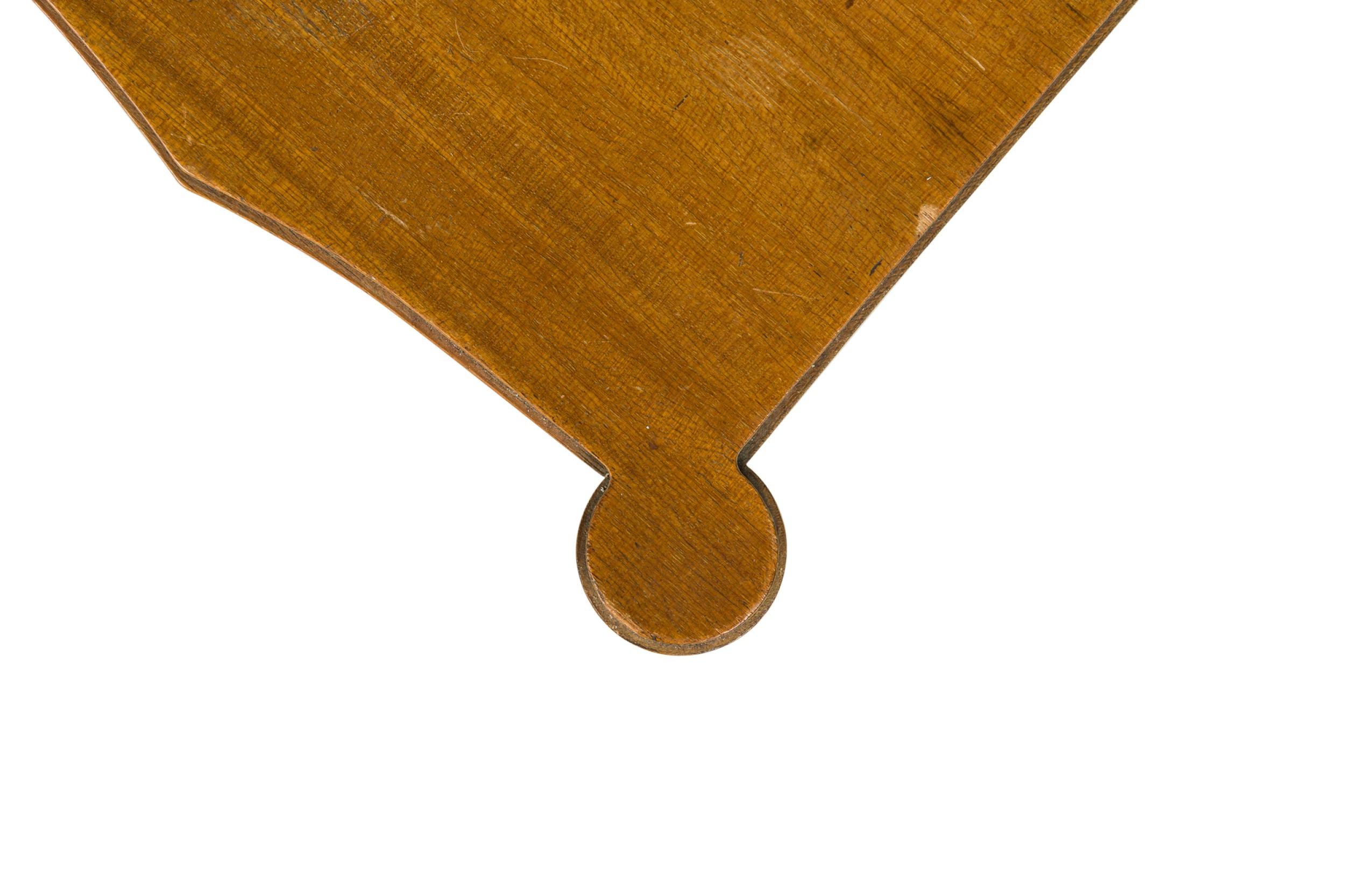 Continental Mid-Century walnut contole table having two drawers with X-shaped brass drawer pulls, resting on four tapered round legs ending in brass sabots. (PAUL FRANKL)