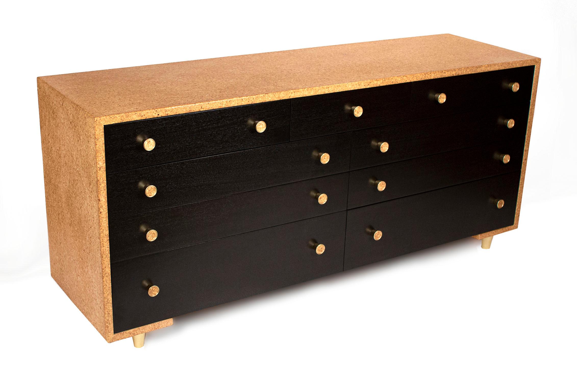 Rare & amazing waterfall nine drawer dresser designed by Paul Frankl. Dresser has a beautiful cork top & sides, black lacquer drawer fronts with inlaid cork and brass pulls and sits on three-inch tall tapered legs.