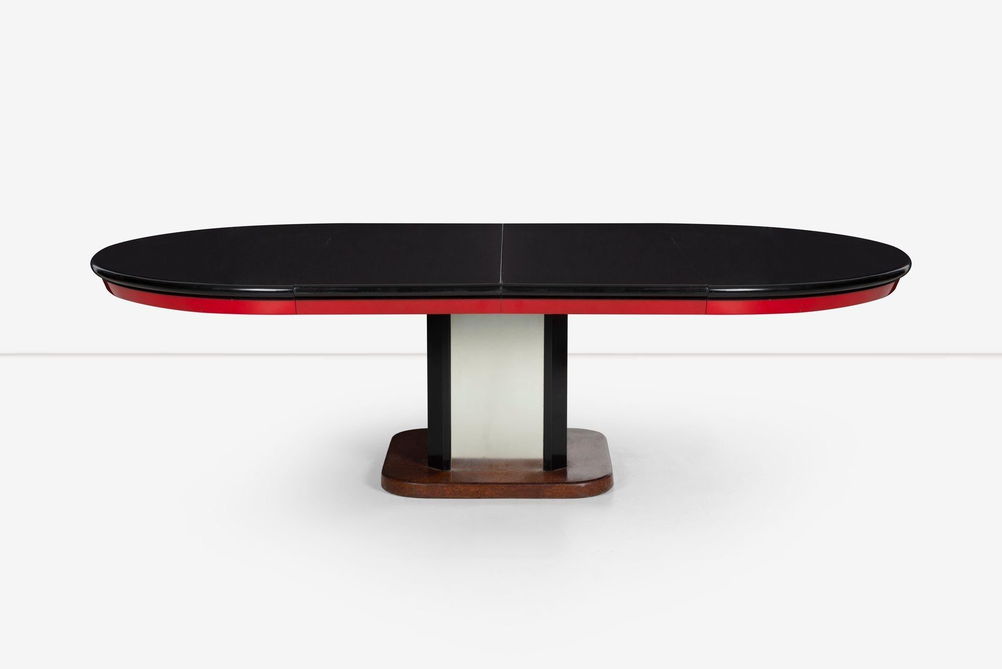 Paul Frankl custom dining table, designed for a project in La Jolla, California 1930c.
Sold with two 24-inch leaves when both are inserted the table measures 108 inches fully extended, comfortably seating 10 to 12.
Lacquered wood and cork base,