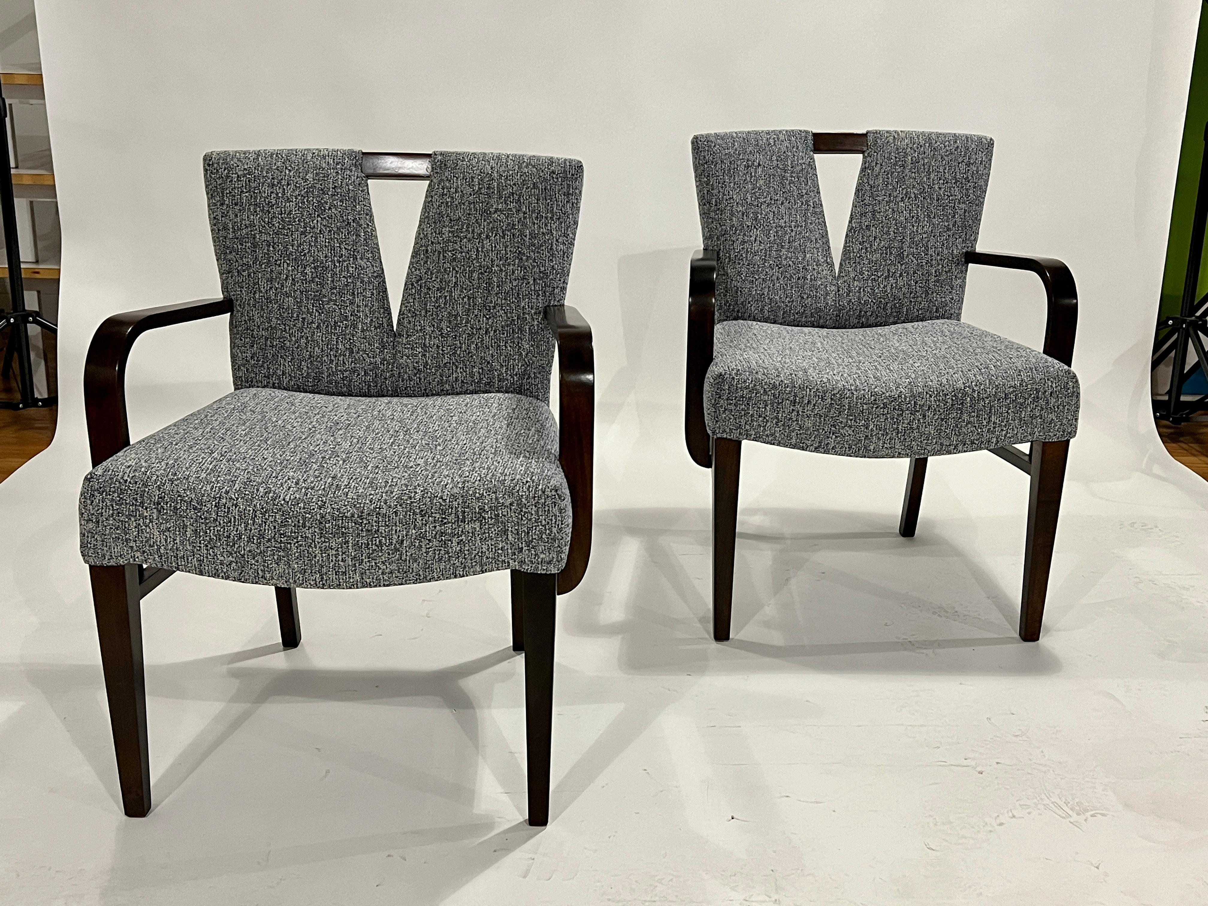 Rare opportunity to acquire this stunning set of Paul Frankl Corset dining chairs by Johnson Furniture Co. The set includes 2 arm chairs and 6 side chairs in restored mahogany wood frames all newly restored, refinished and reupholstered in a blue