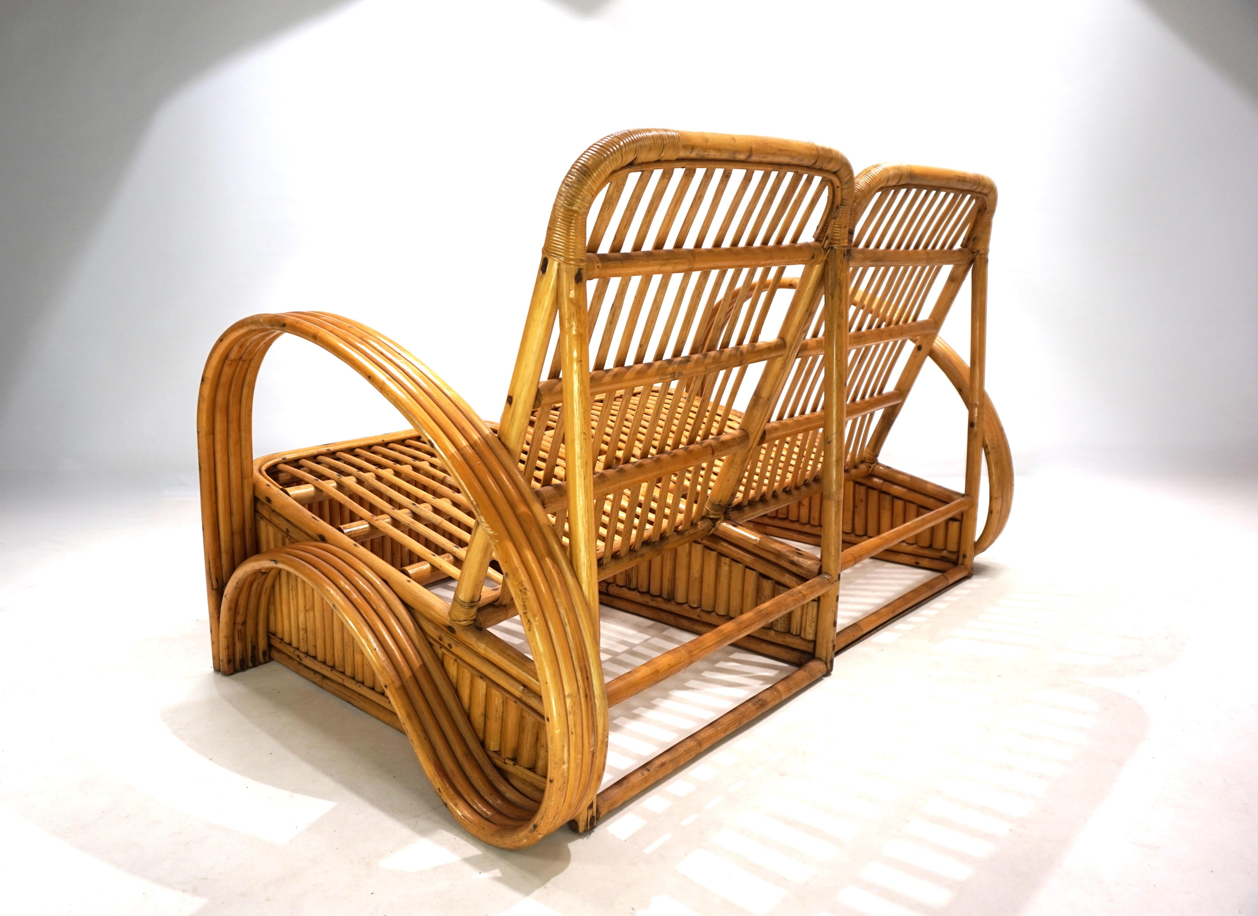 A wonderful rattan two-seater sofa with four-strand, wave-shaped rattan armrests. The sofa is in excellent condition with minimal, attractive patina. All joints between the two individual sections are solid and intact. The sofa's dimensions provide