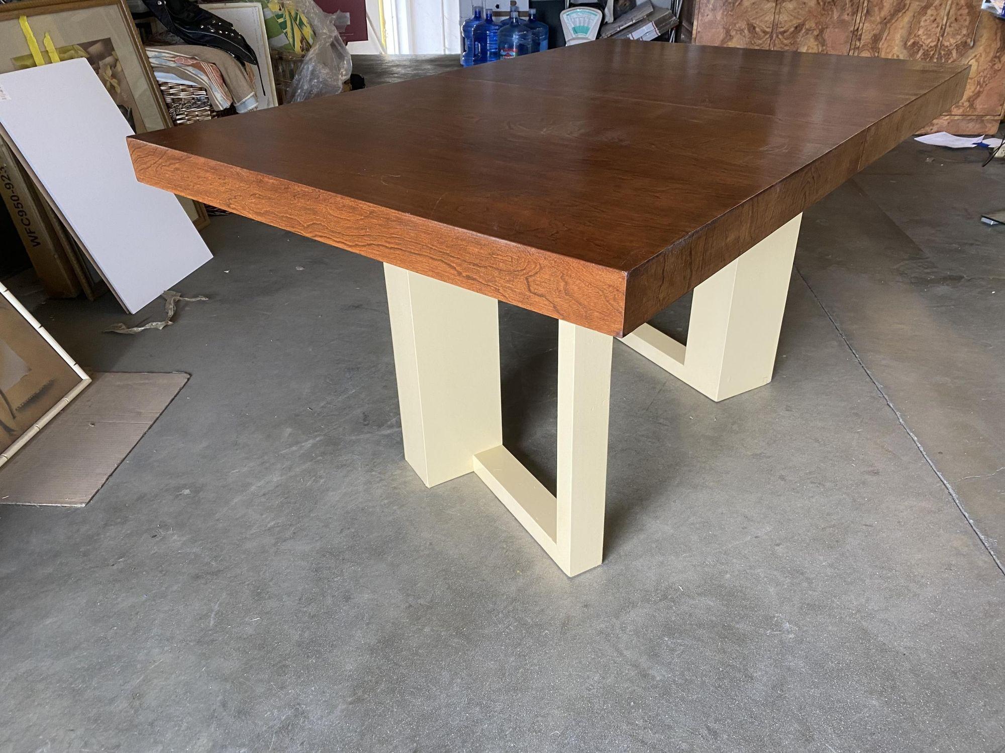Elegant Walnut top dining table, designed by Paul Frankl for The Johnson Furniture Company, American, circa 1940. This table has been refinished in a slight red hue on the tabletop with an off-white base.