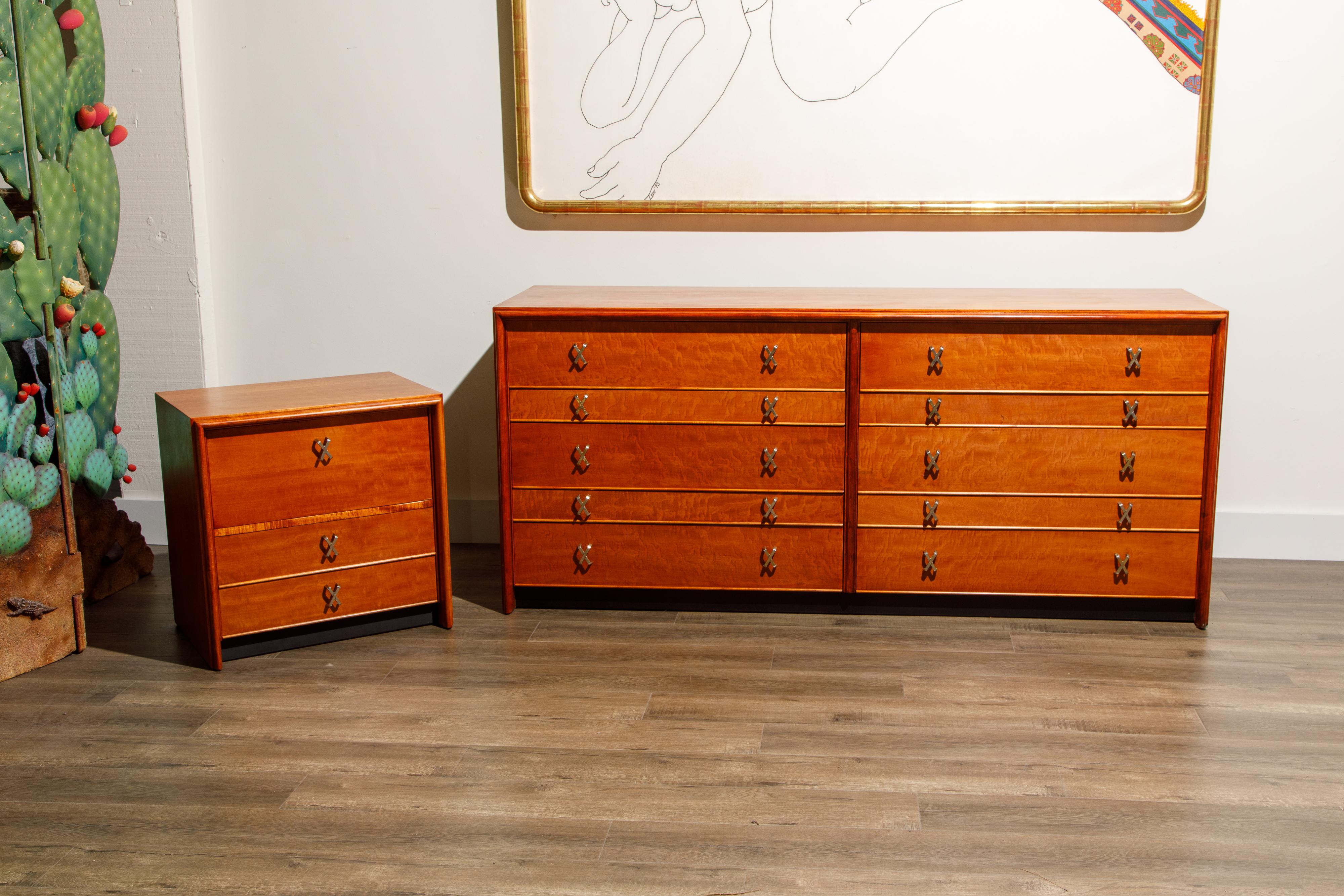 This fantastic 1950s ten-drawer double dresser and nightstand was designed by Paul Frankl for Johnson Furniture and retailed by John Stuart during the 1950s. Crafted from a beautiful exotic wood, front drawers appears to be possibly a quilted maple
