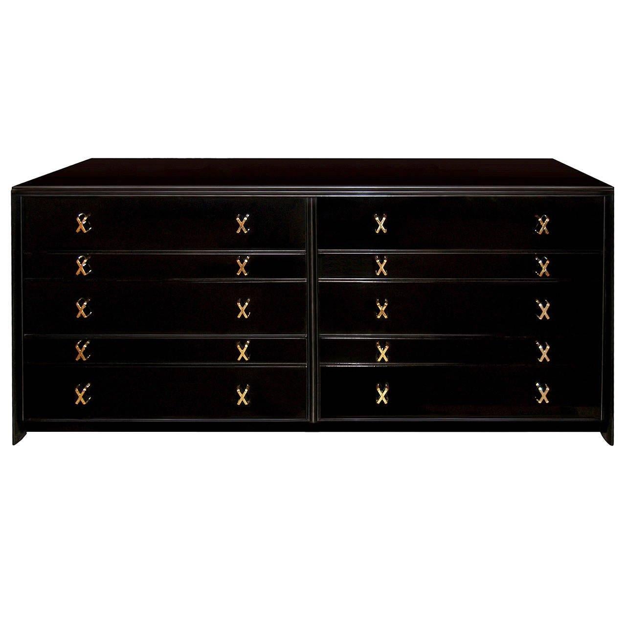 An ebonized walnut ten-drawer dresser with solid brass X-pulls by Paul Frankl.

American, Circa 1940's

This item is in stock.
