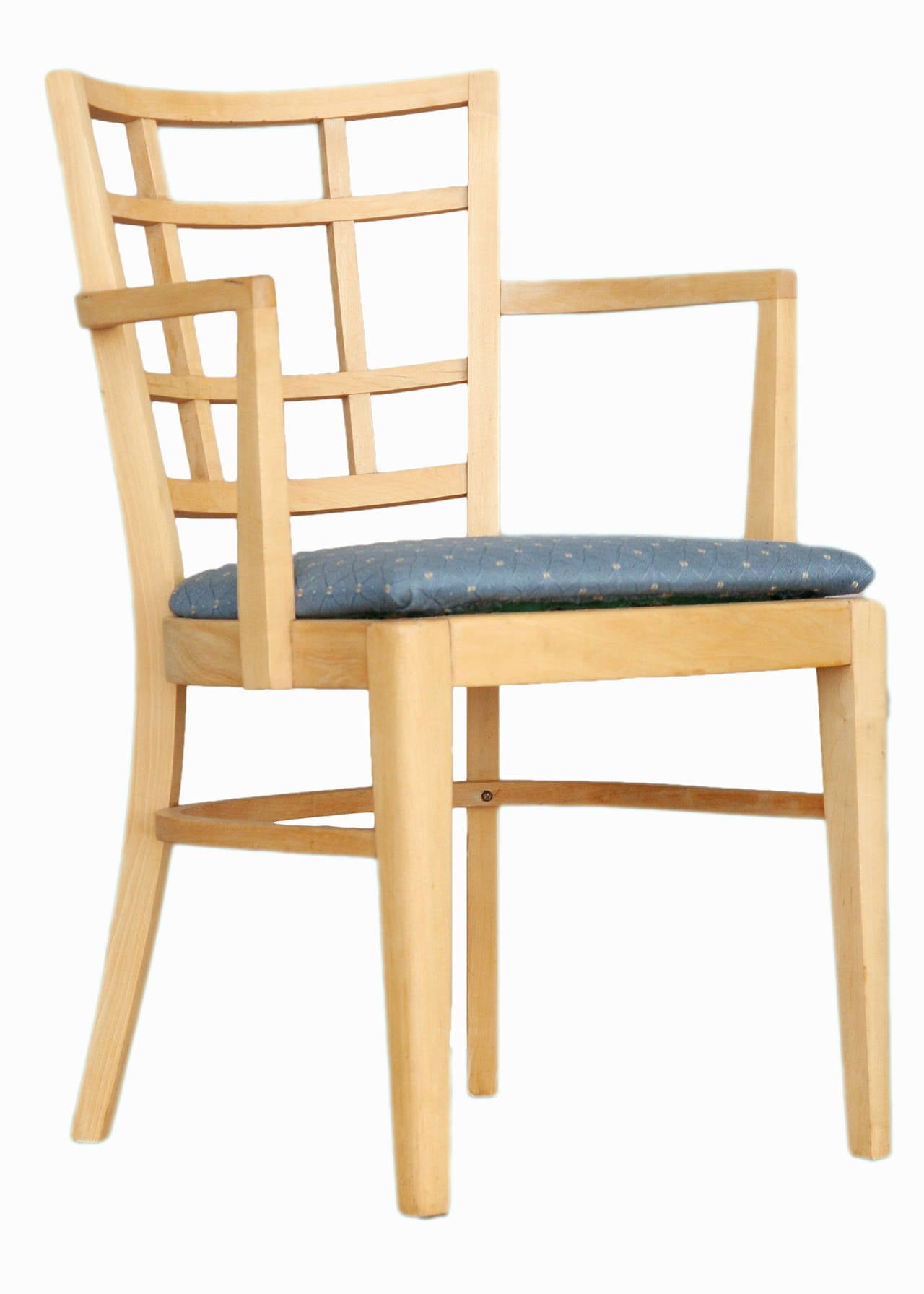 Set of lattice-back dining chairs by Paul Frankl for Brown Saltman group. The chairs upholstered in high-quality blue cotton fabric. The set includes seven captain's chairs.

North America, circa 1940.