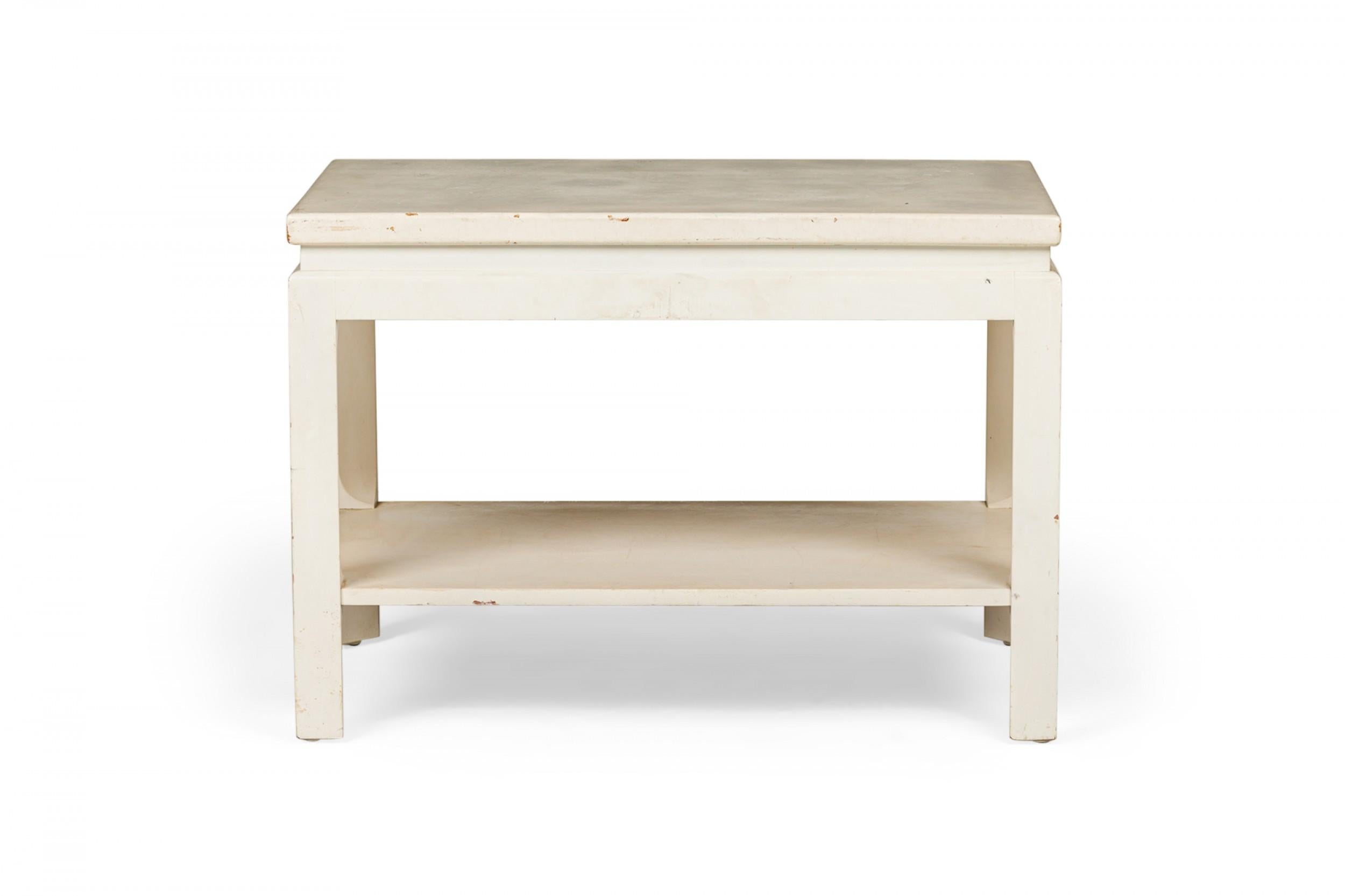 Mid-Century rectangular end / side table with a white painted cork top resting on a white painted wooden frame with a lower rectangular stretcher shelf and four square legs. (PAUL FRANKL FOR JOHNSON FURNITURE COMPANY)(Similar tables: DUF0726,