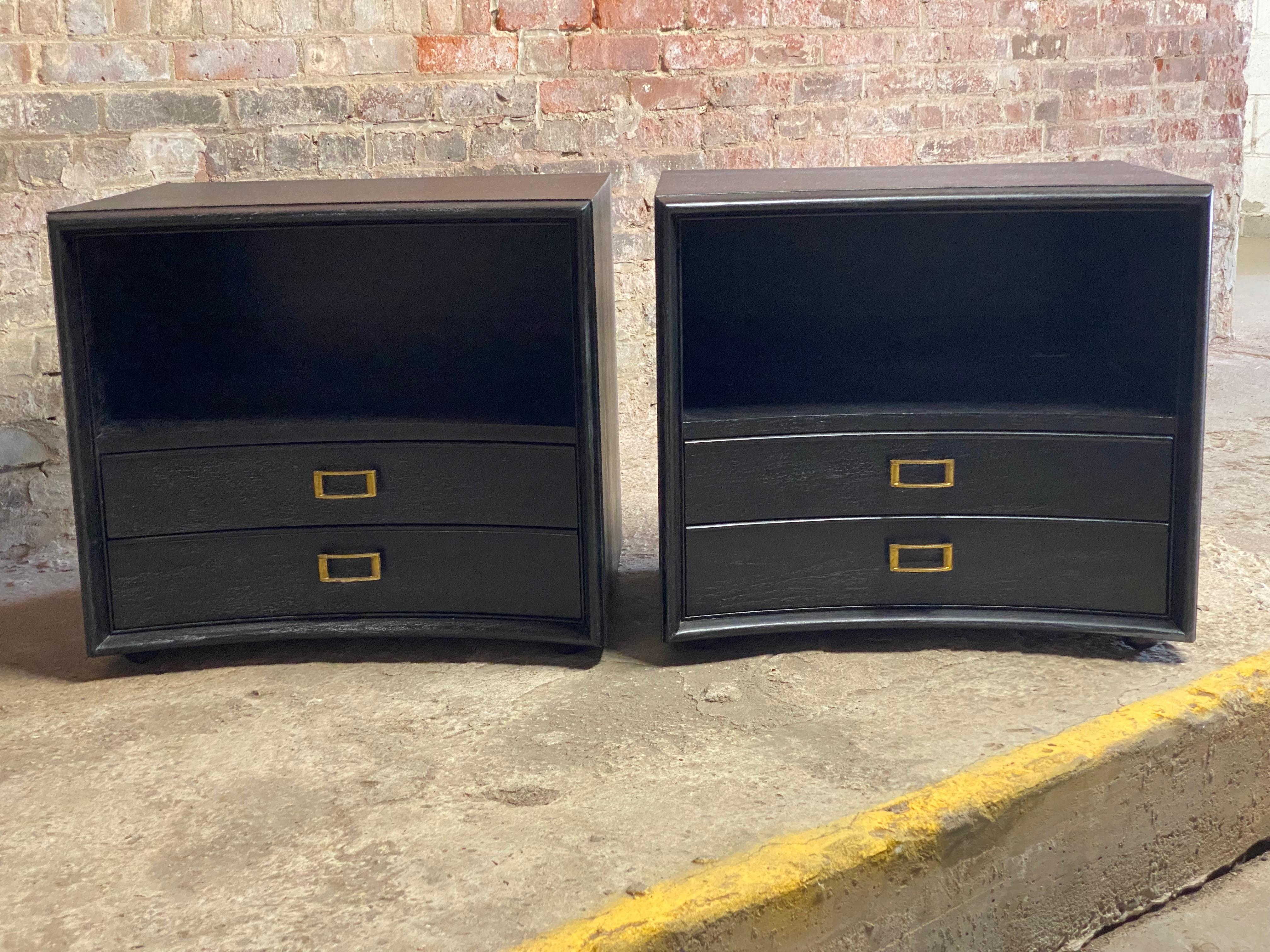A fine pair of limed and ebonized Paul Frankl for Johnson Furniture Company two drawer end tables. Burn in mark and John Stuart retailer labels are in the top drawer. The pair features a nicely contoured concave front, brass hardware, dowel feet and