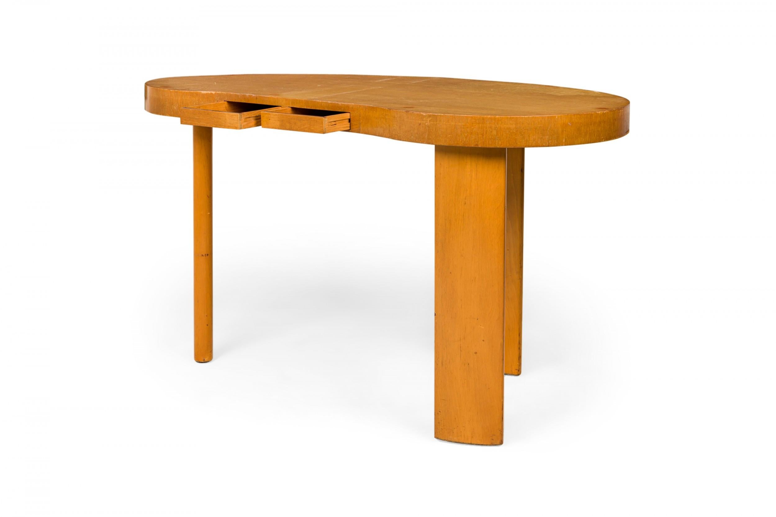 Mid-Century wooden 'pallet' kidney-shaped desk with two drawers flush to desk edge, resting on three rectangular legs with rounded edges. (PAUL FRANKL FOR JOHNSON FURNITURE COMPANY)