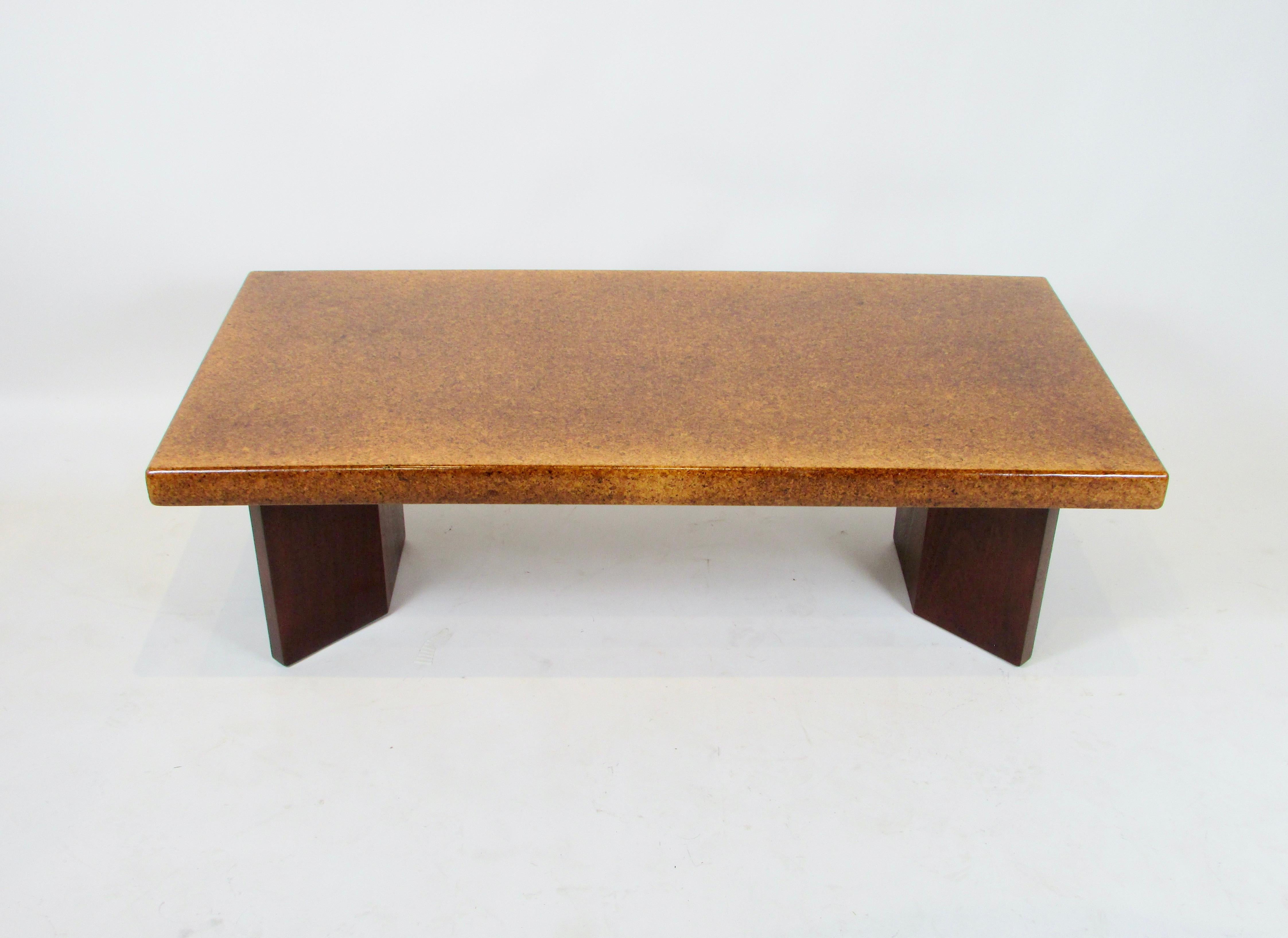  Paul T. Frankl  designed a large collection of mid century modern pieces for Johnson furniture . Introduced after the war this table is a fine example from that collection . Original cork top sits on mahogany plinth bases . Both top and bases have